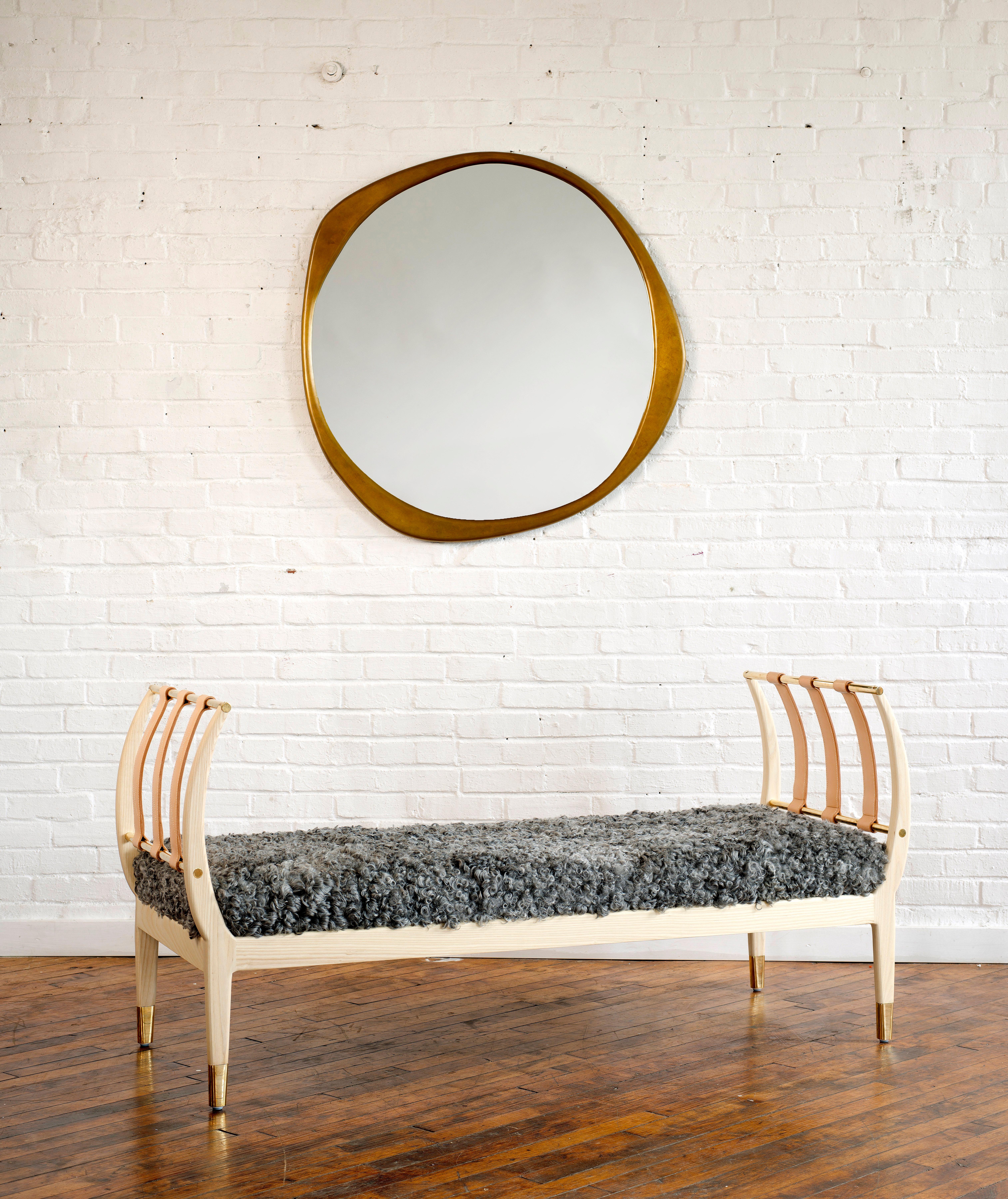 Inspired by the rib of a whale, our Rib Bench features curved lines that are graceful, solid and strong. The bench features solid brass rods and sabots, and is complemented by the arch of vegetable tanned leather straps. The leather straps are