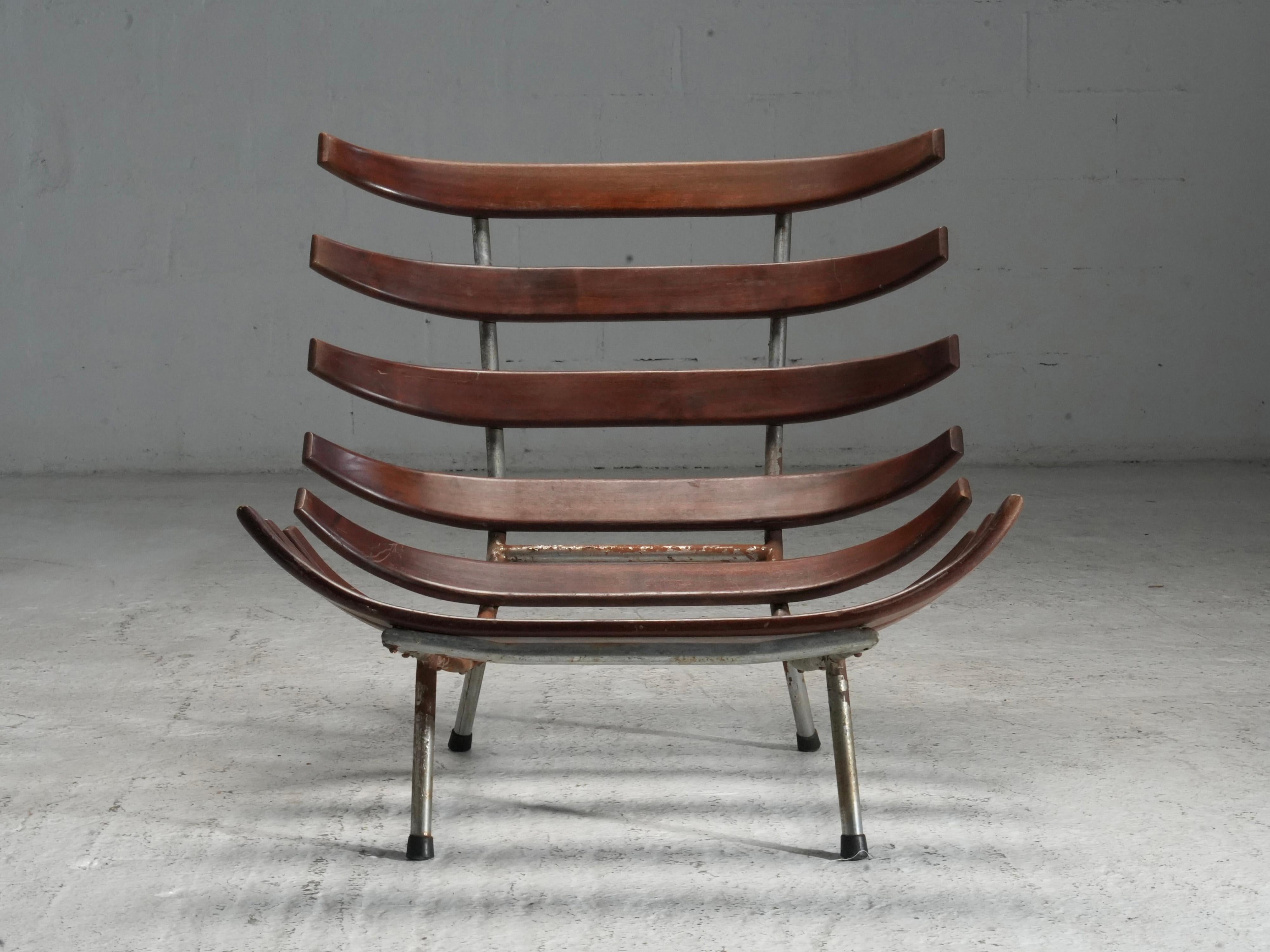 Rib Chair in Teak and Metal, Brazil, 1950's

This rib chair takes cues from the work of Martin Eisler and Carlo Hauner — especially in how the frame and structure are allowed to speak. The open, curved wooden ribs create a sculptural form, while the