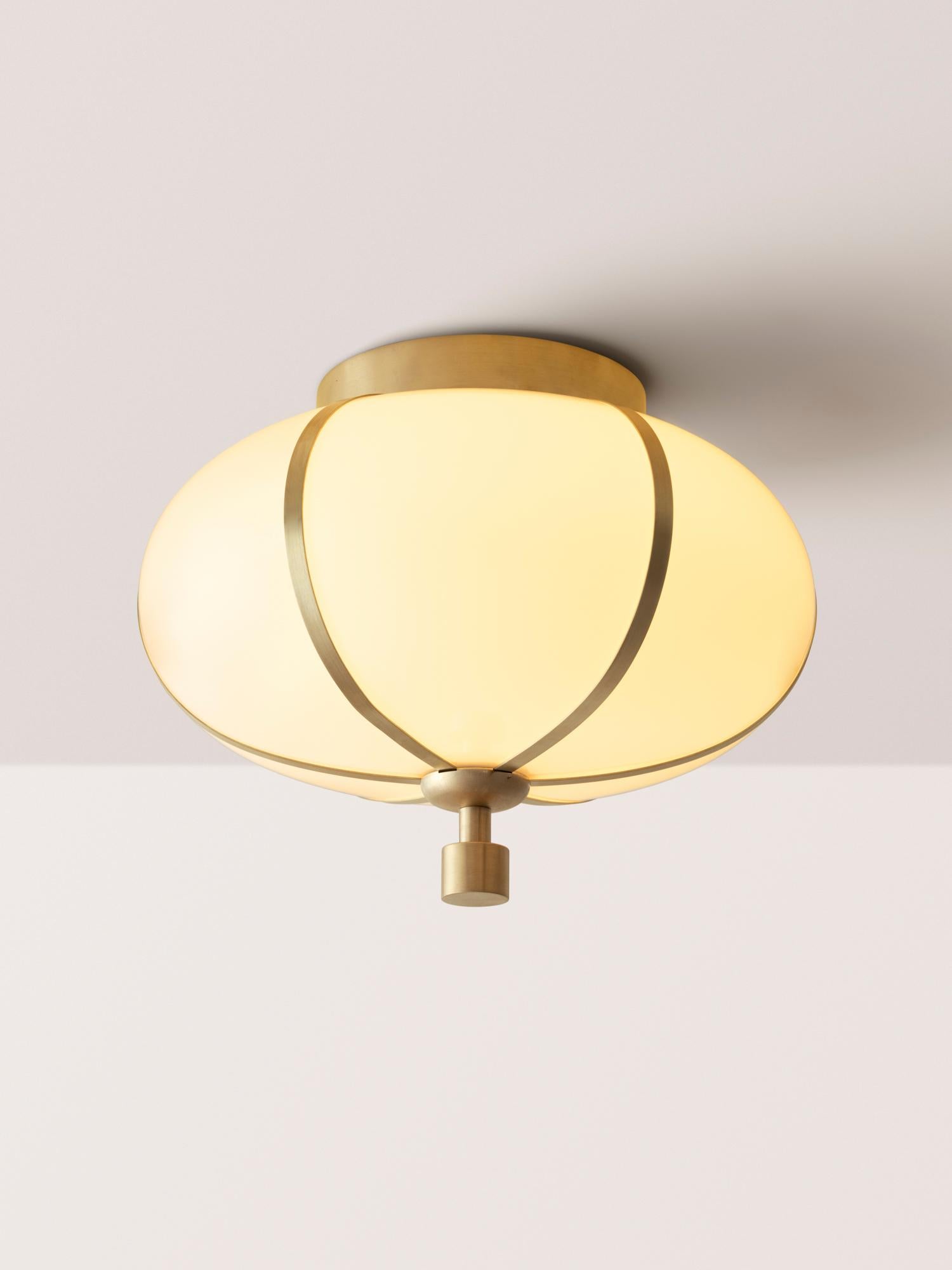 L'affleurant Rib - Small Ellipse est soufflé en Italie et délicatement encadré par de fines nervures en laiton. Un épi de faîtage cylindrique en laiton, avec en option du cuir ou du daim enveloppé à la main, allonge le luminaire et ajoute une touche