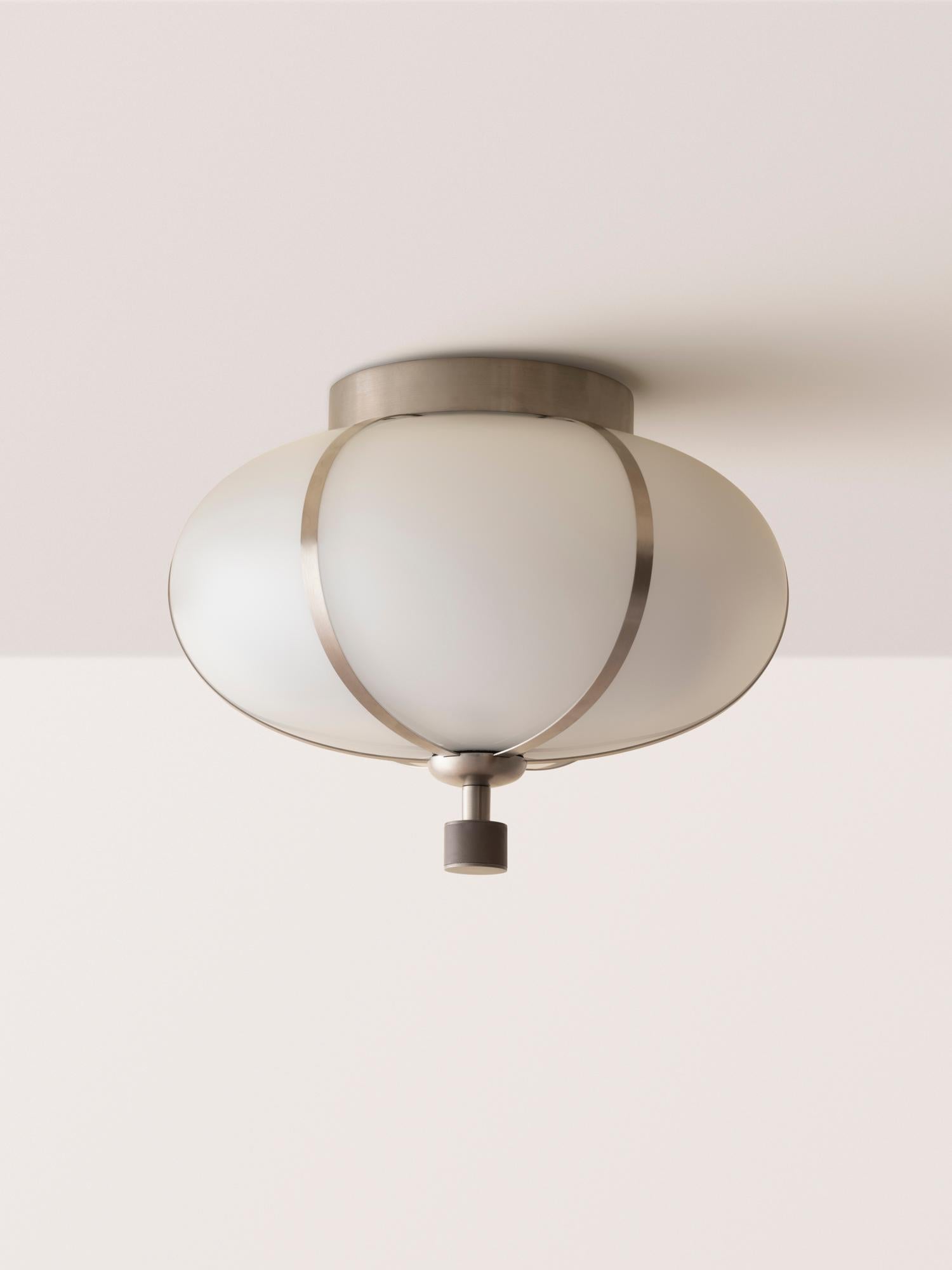 The Rib Flush Mount - Small Ellipse is blown in Italy and delicately framed by thin brass ribs. A cylindrical brass finial, with optional hand-wrapped leather or suede, elongates the fixture and adds a finishing touch of refinement.

This listing is