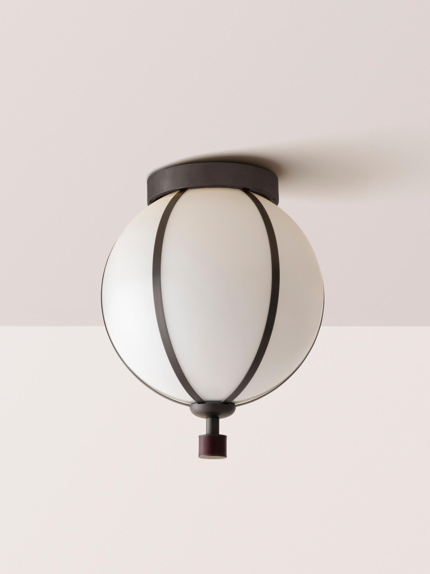 The Rib Flush Mount - Small Sphere is blown in Italy and delicately framed by thin brass ribs. A cylindrical brass finial, with optional hand-wrapped leather or suede, elongates the fixture and adds a finishing touch of refinement.

Available in a