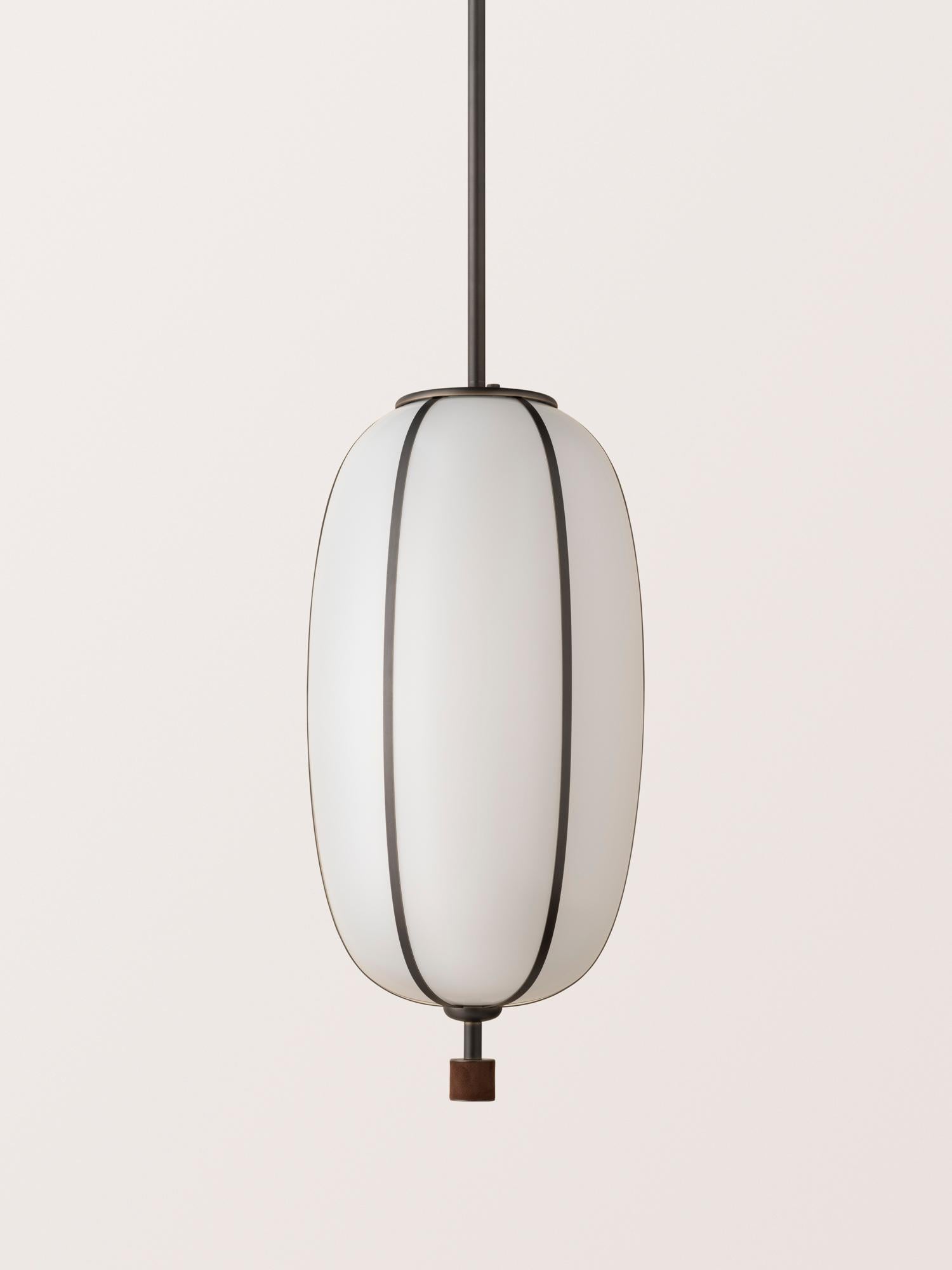 The Rib Pendant - Capsule is blown in Italy and delicately framed by thin brass ribs. A cylindrical brass finial, with optional hand-wrapped leather or suede, elongates the fixture and adds a finishing touch of refinement.

This listing is priced