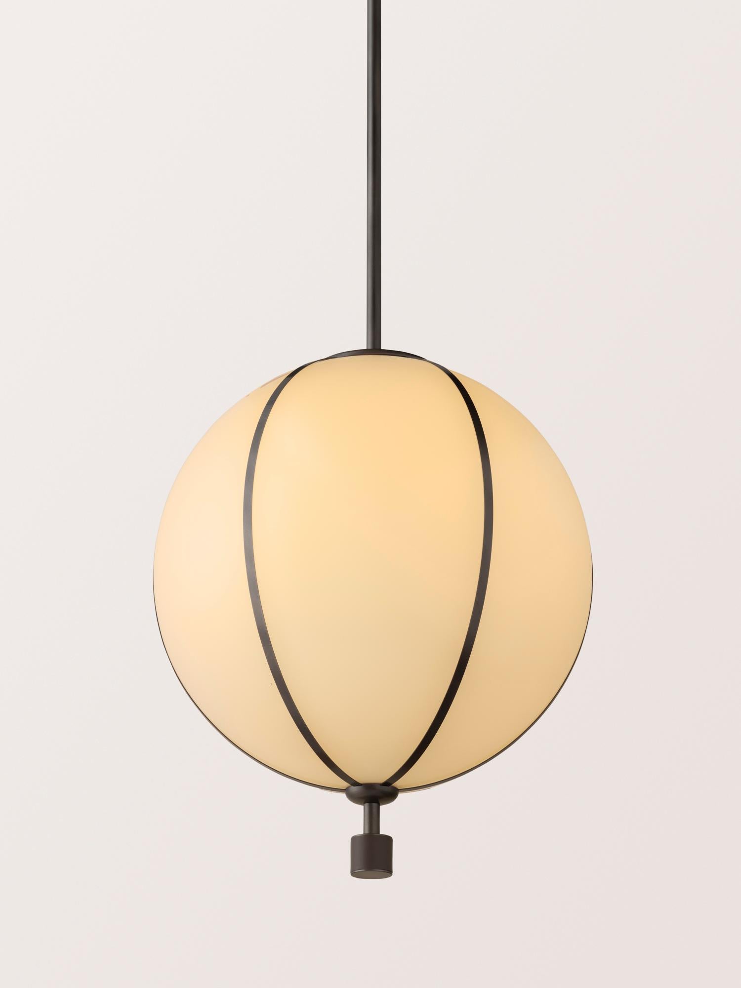 The Rib Pendant - Large Sphere is blown in Italy and delicately framed by thin brass ribs. A cylindrical brass finial, with optional hand-wrapped leather or suede, elongates the fixture and adds a finishing touch of refinement.

This listing is