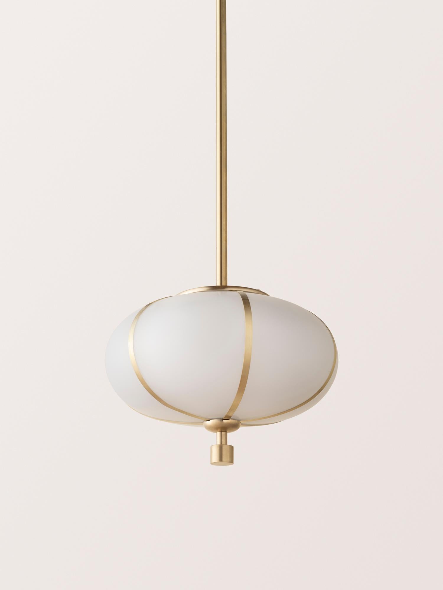 The Rib Pendant - Small Ellipse is blown in Italy and delicately framed by thin brass ribs. A cylindrical brass finial, with optional hand-wrapped leather or suede, elongates the fixture and adds a finishing touch of refinement.

This listing is