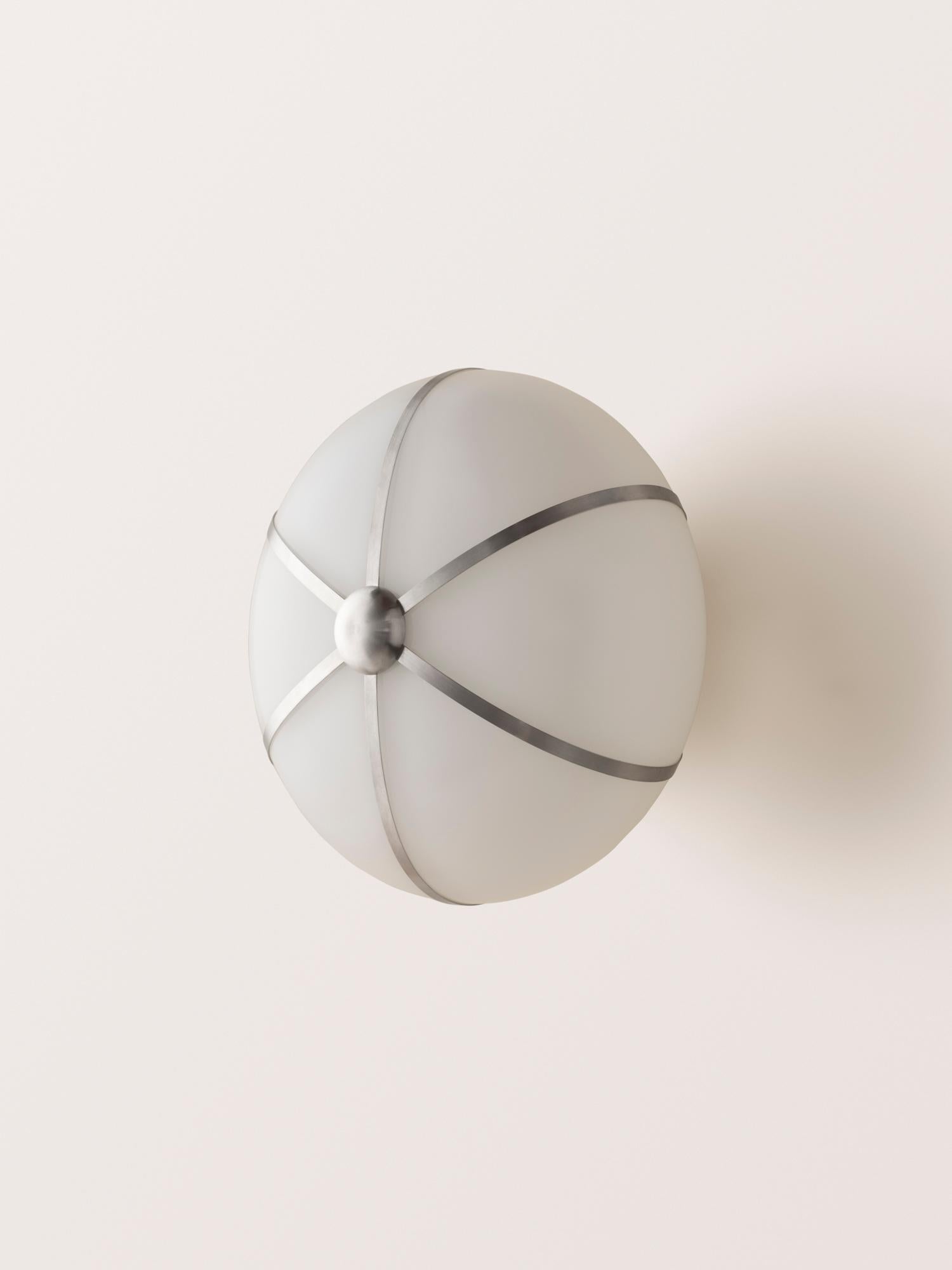 The Rib Sconce - Small Ellipse is blown in Italy and delicately framed by thin brass ribs.

This listing is priced for the satin nickel finish. Please inquire for pricing of other finish options.
