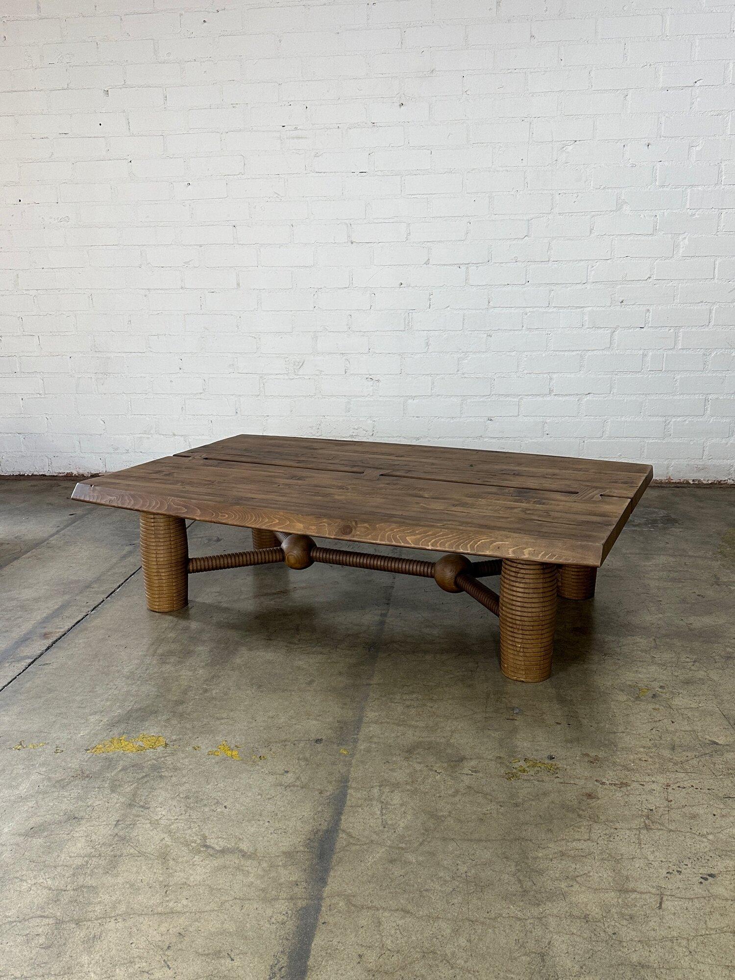W60 D39 H16

Gently used contemporary coffee table made using reclaimed oak. Item features ribbed legs and surface split down the center. This item was used for staging and shows well as intended with aged hues and wood imperfections. Pick up this