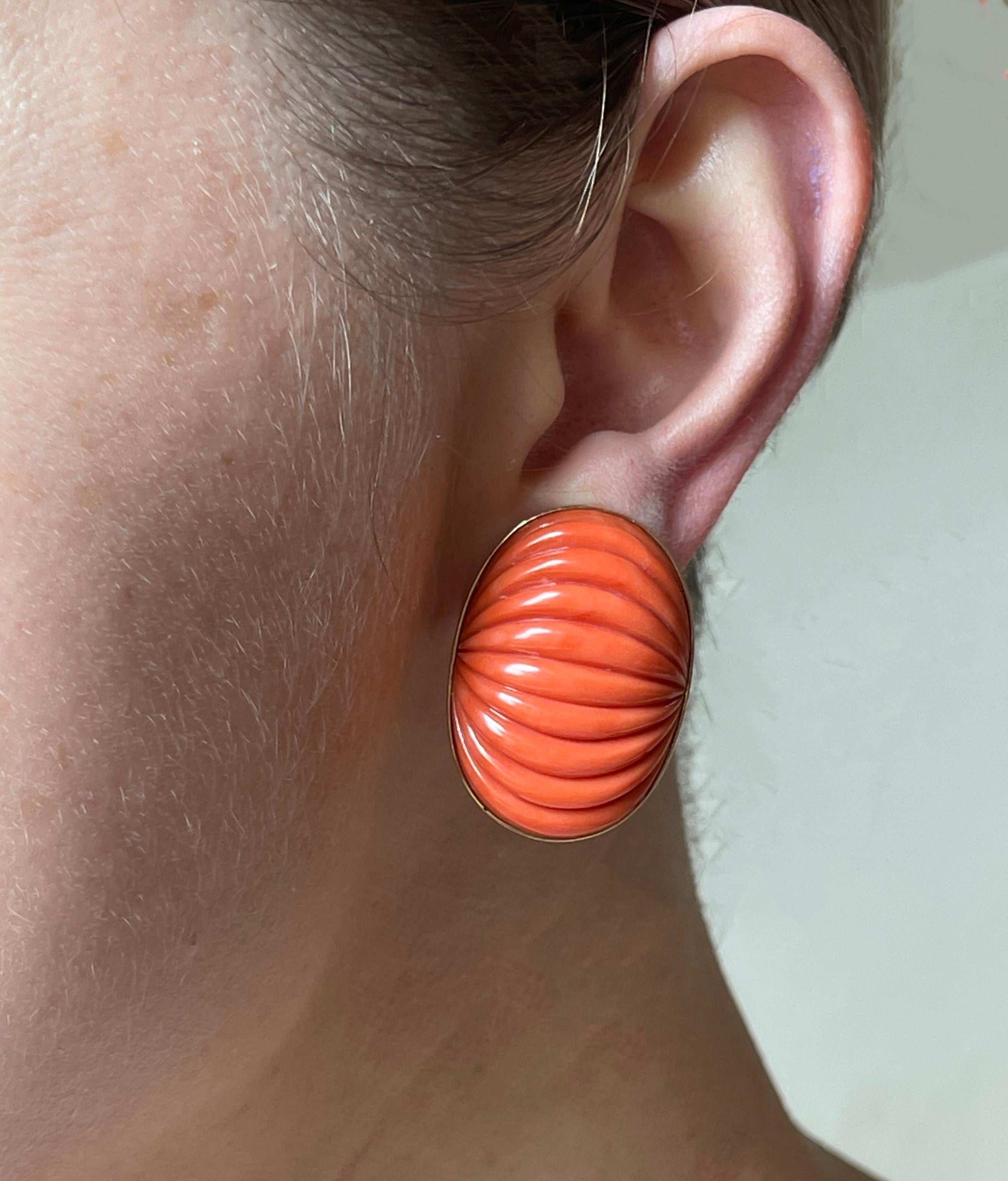Pair of vintage 18k gold oval earrings, with carved ribbed coral. Earrings measure 1.25