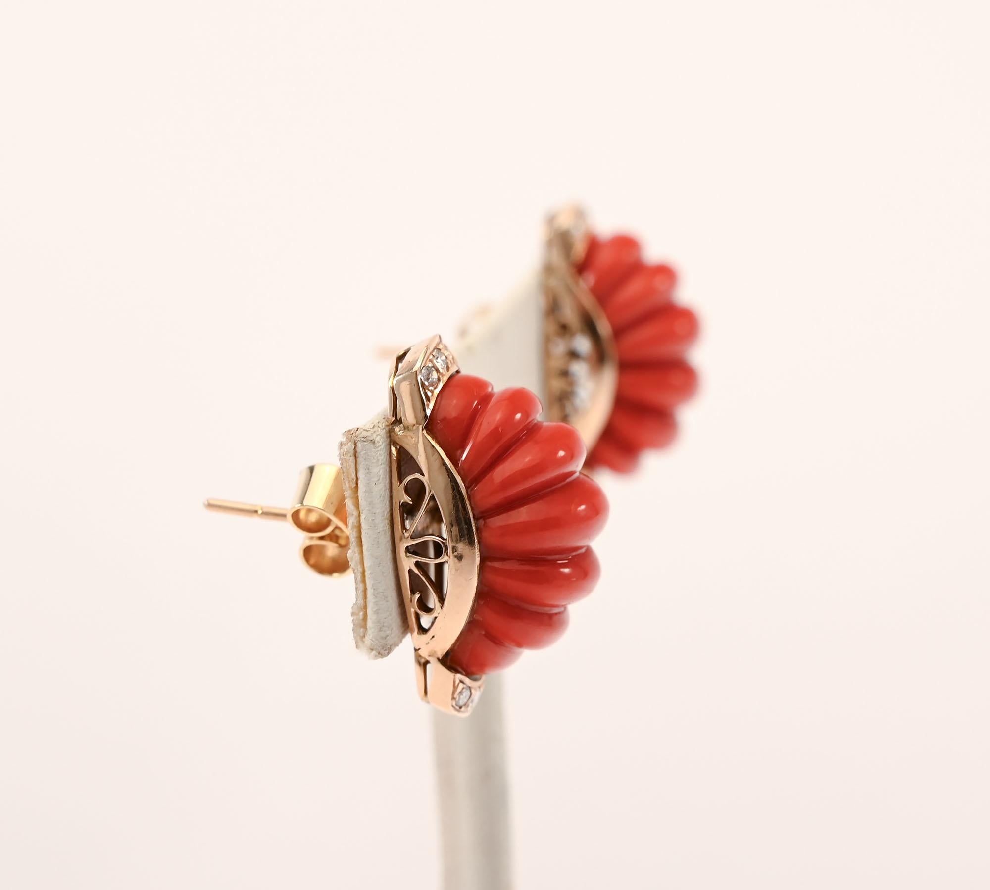 Ribbed coral half hoop earrings are set in 14 karat gold. Four diamonds each on top and bottom add a hint of sparkle. Backs are posts that can be modified to clips. The earrings are half an inch wide and 7/8 of an inch long. A three part curvilinear