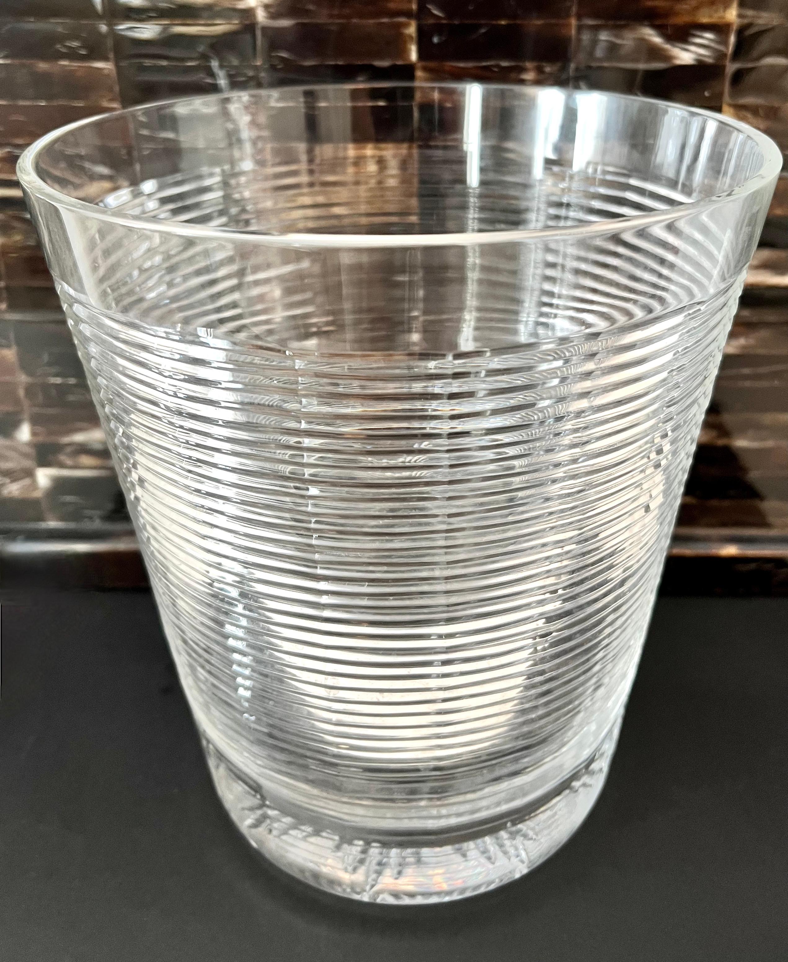 A wonderful ice bucket or champagne bucket of ribbed glass and a start feature on the bottom. A compliment to any bar, especially those featuring shiny glass - the piece is of good weight an is definitely unique and an eye catcher.