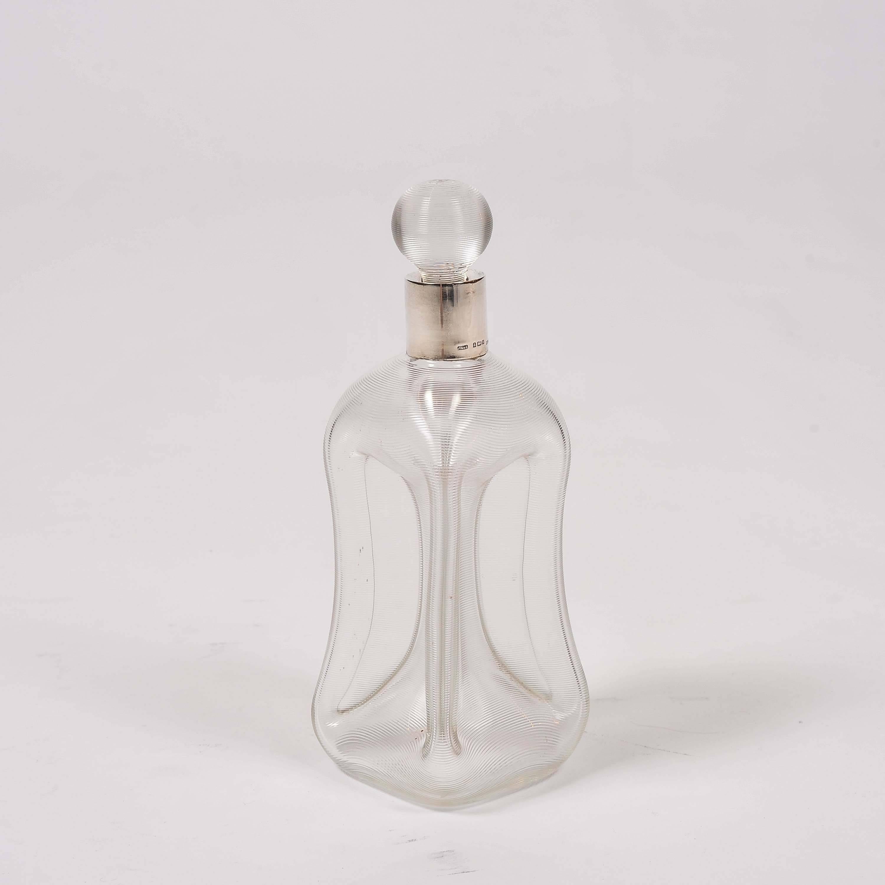 An Edwardian decanter by John Grinsell & Sons, ribbed pinch glass with sterling silver collar. 

Hallmarked Birmingham 1901.

Weight: 0.9 kg.

John Grinsell & Sons History:

The business was established in Birmingham, England, circa 1864, as