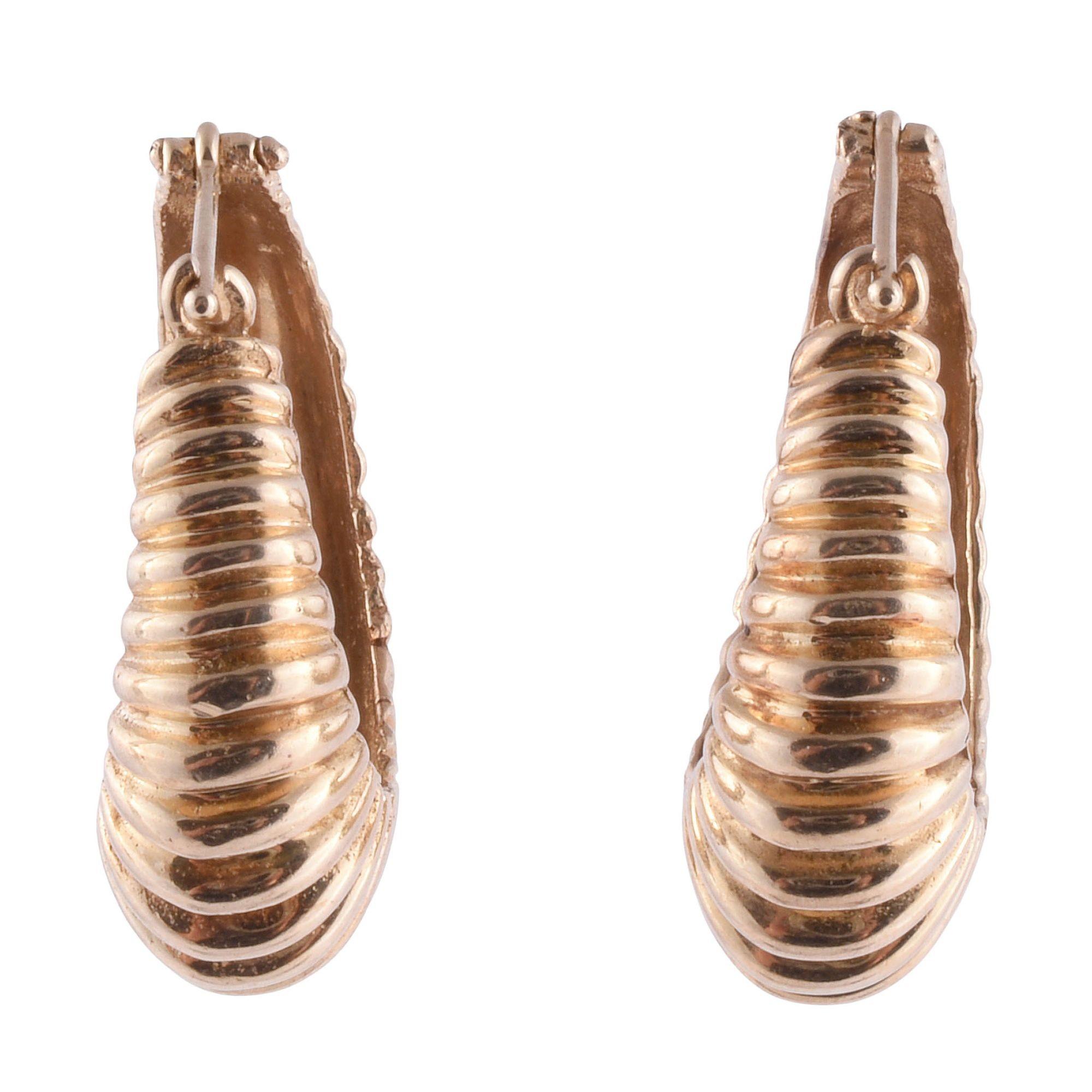 Vintage ribbed hoop earrings, circa 1970. These vintage earrings in a ribbed hoop style are crafted in 14 karat yellow gold. [KIMH 547]