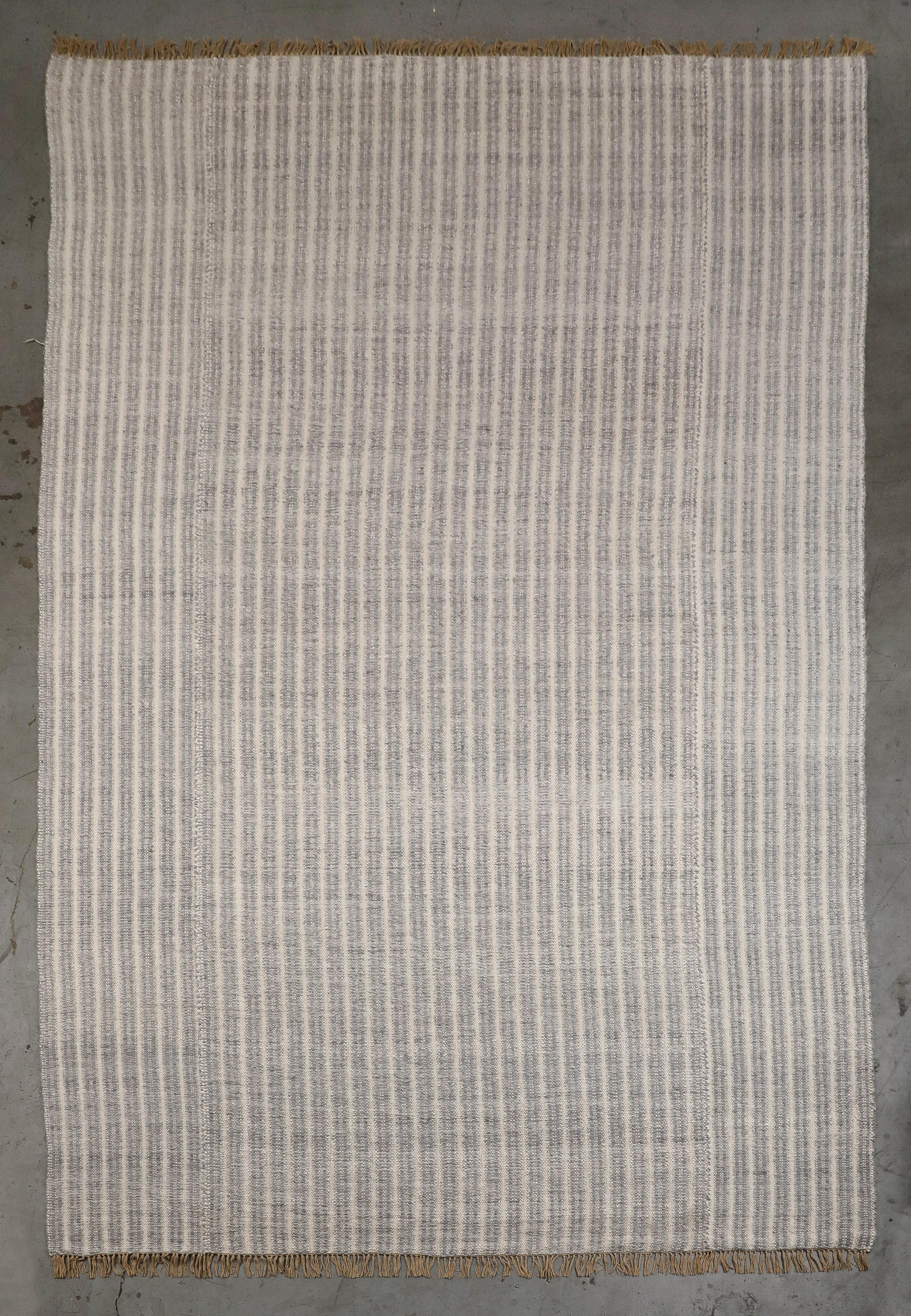 Ribbed mohair area rug custom made by Ennui Home in 2021. Handmade by artisans in Africa, this rug has never been used in a home. Blue-grey and cream stripes with a short tan hand-knotted fringe. 