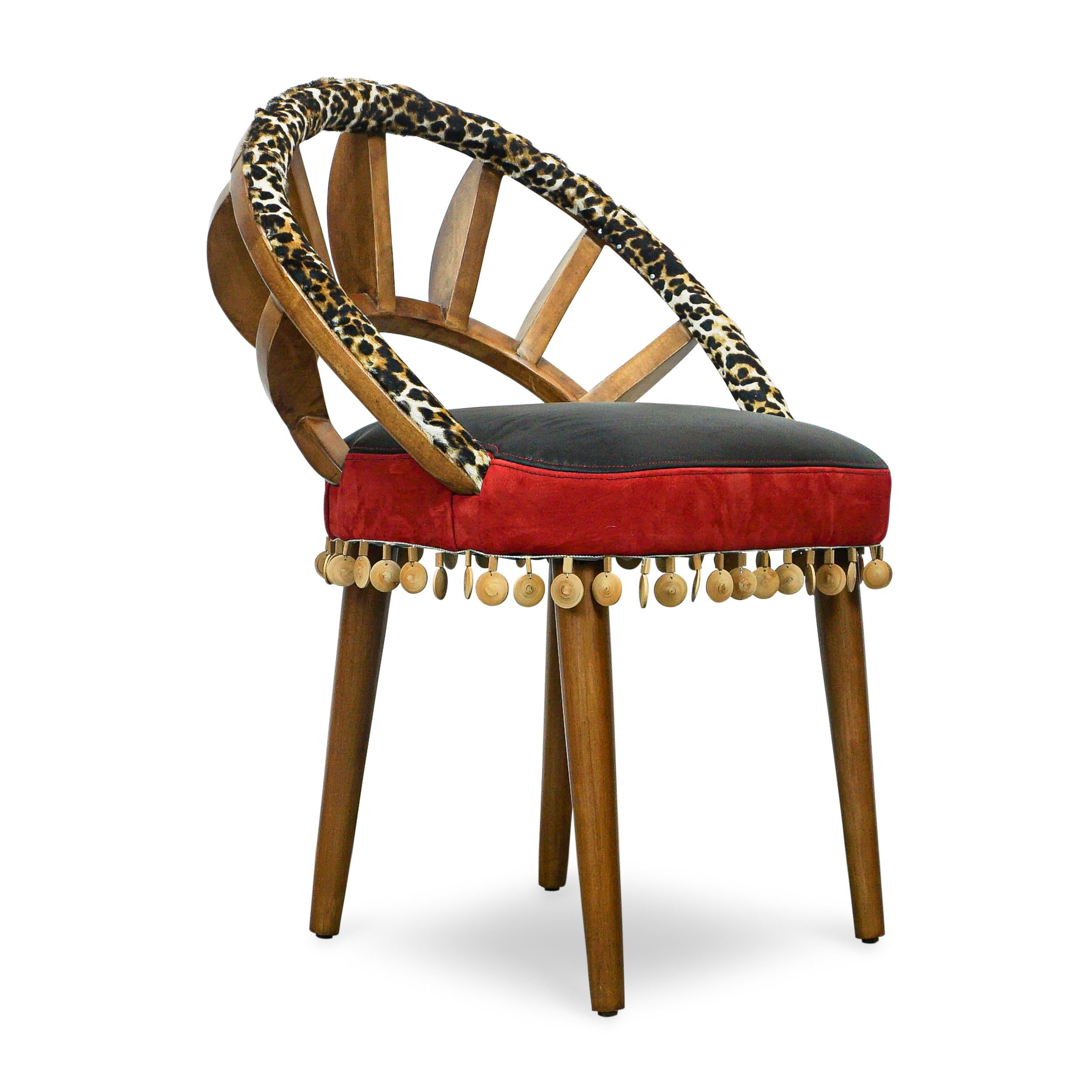 Purchase may be limited to quantity 2 or more, just ask.
Dining / side / occasional chair with ribbed exposed wood frame (maple). Back rail upholstered with cheetah printed hair on hide. Seat upholstered with black leather and red suede and finished
