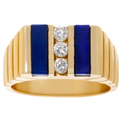 Ribbed yellow gold ring with 3 channel set diamonds 
lapiz lazuli accents.