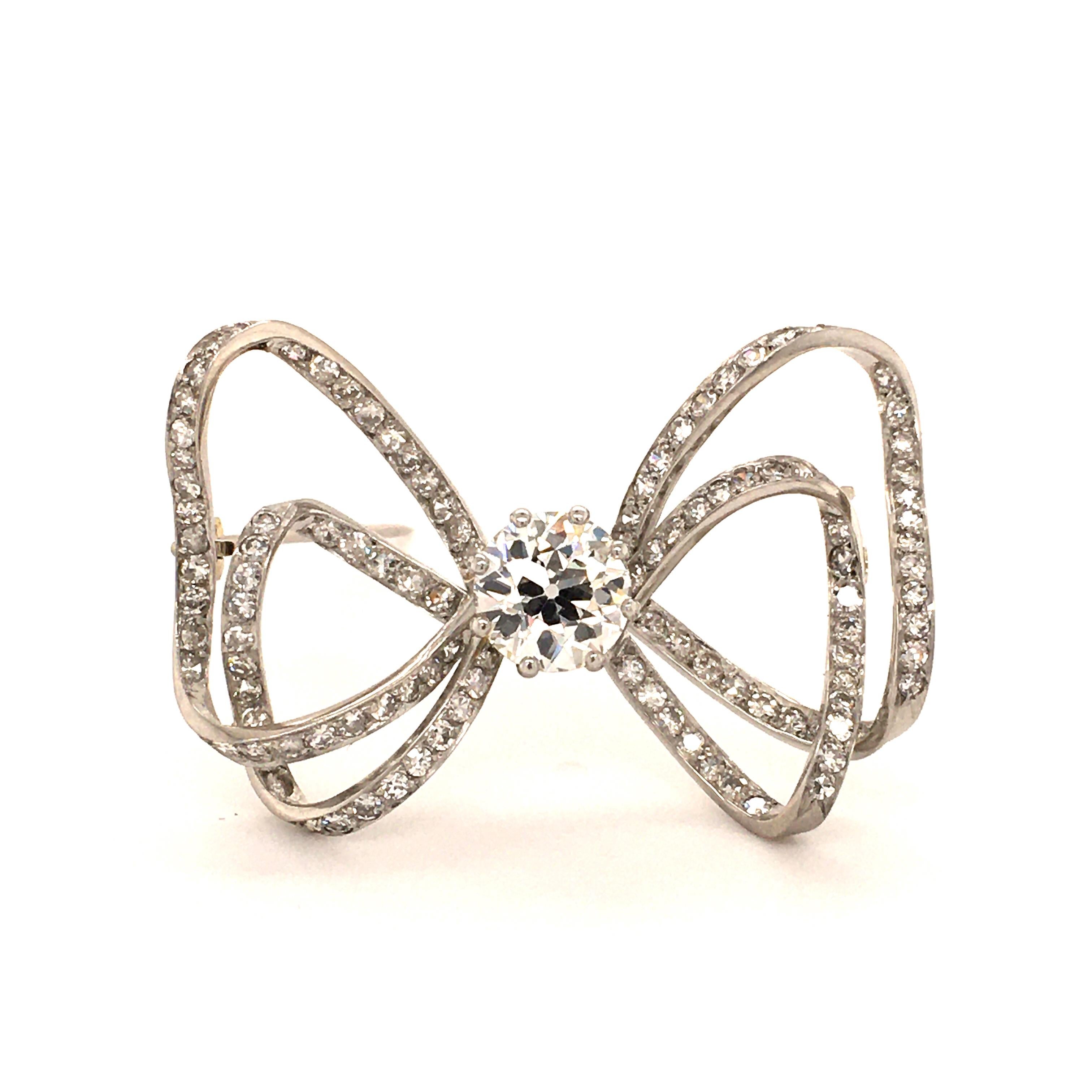 Lovely Ribbon Brooch in White Gold 750. Prong set with one fine old cut Diamond of 2.03 ct and J-si1 quality. Carefully set with 112 single cut Diamonds. Very beautiful item.

In the past, jewelry was always given meaning, if you want to know more,