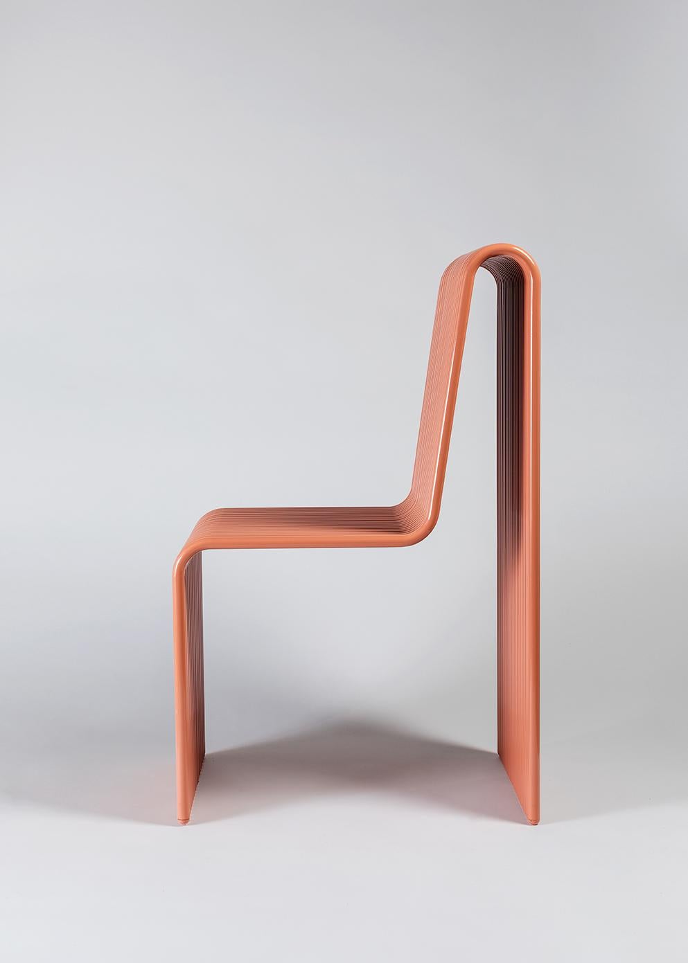 Simultaneously delicate and bold, the Ribbon chair is a playful addition to the LAUN catalog. The layered aluminum tubes stack together to form either a solid or multicolored array and allows for custom widths in an infinite combination of forms.