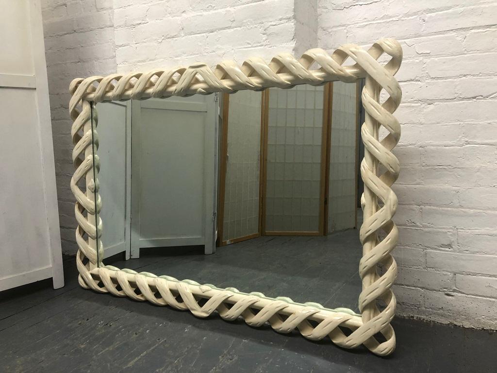 Ribbon mirror style of James Mont. The mirror has an off-white painted frame. Can be used vertically or horizontally. 
 