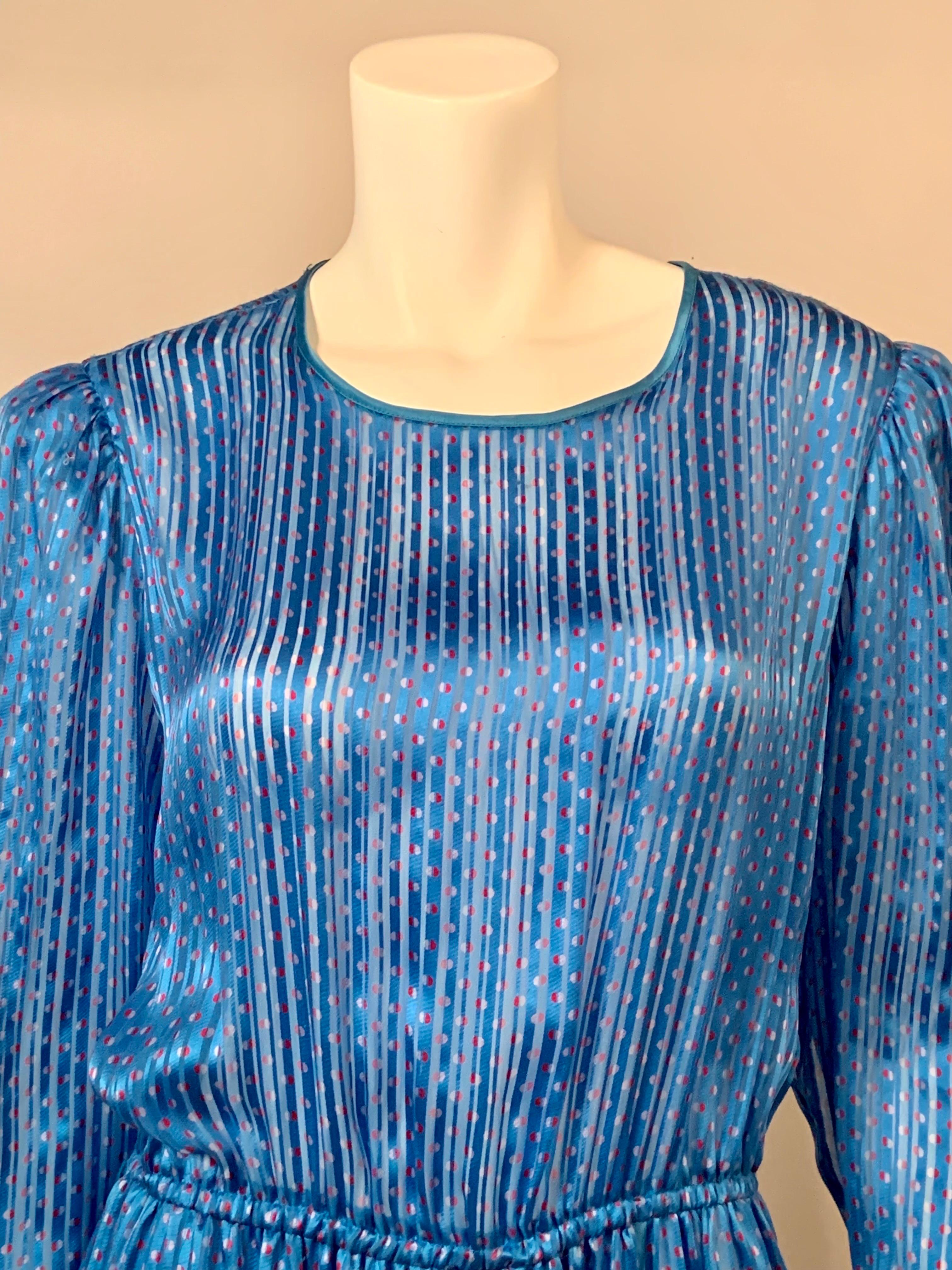The fabric is the story of this Neiman Marcus gown made from a woven ribbon silk print with a blue background and red and white dots.  The dress has a round neckline, long sleeves and a faux wrap skirt all bound in matching blue satin.  There is a