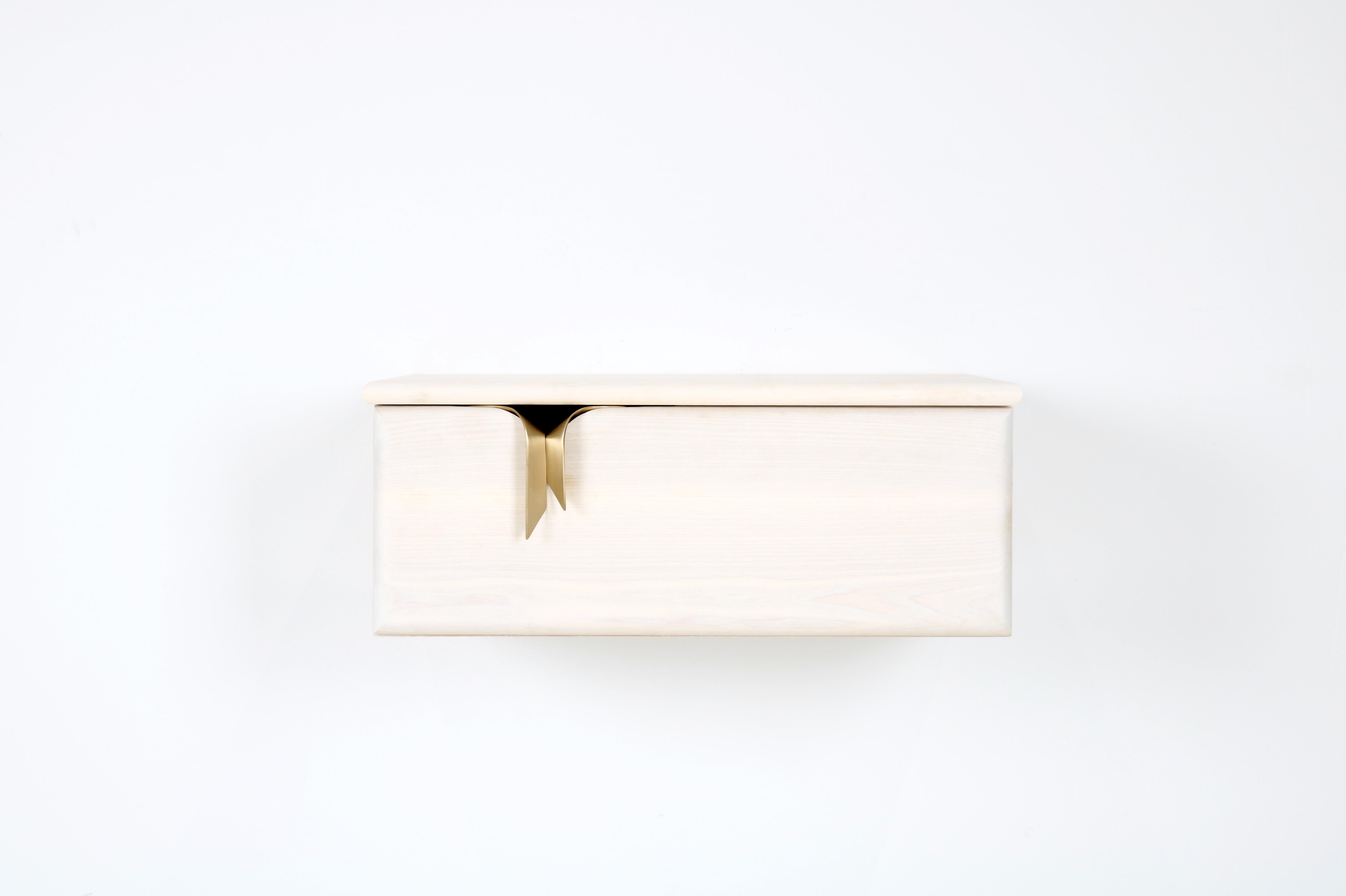 An interest in the translation of textile languages and soft surfaces through furniture forms has led to the development of a unique hardware and storage collection. Inspired by ribbons and communicated through hand cast solid bronze hardware and