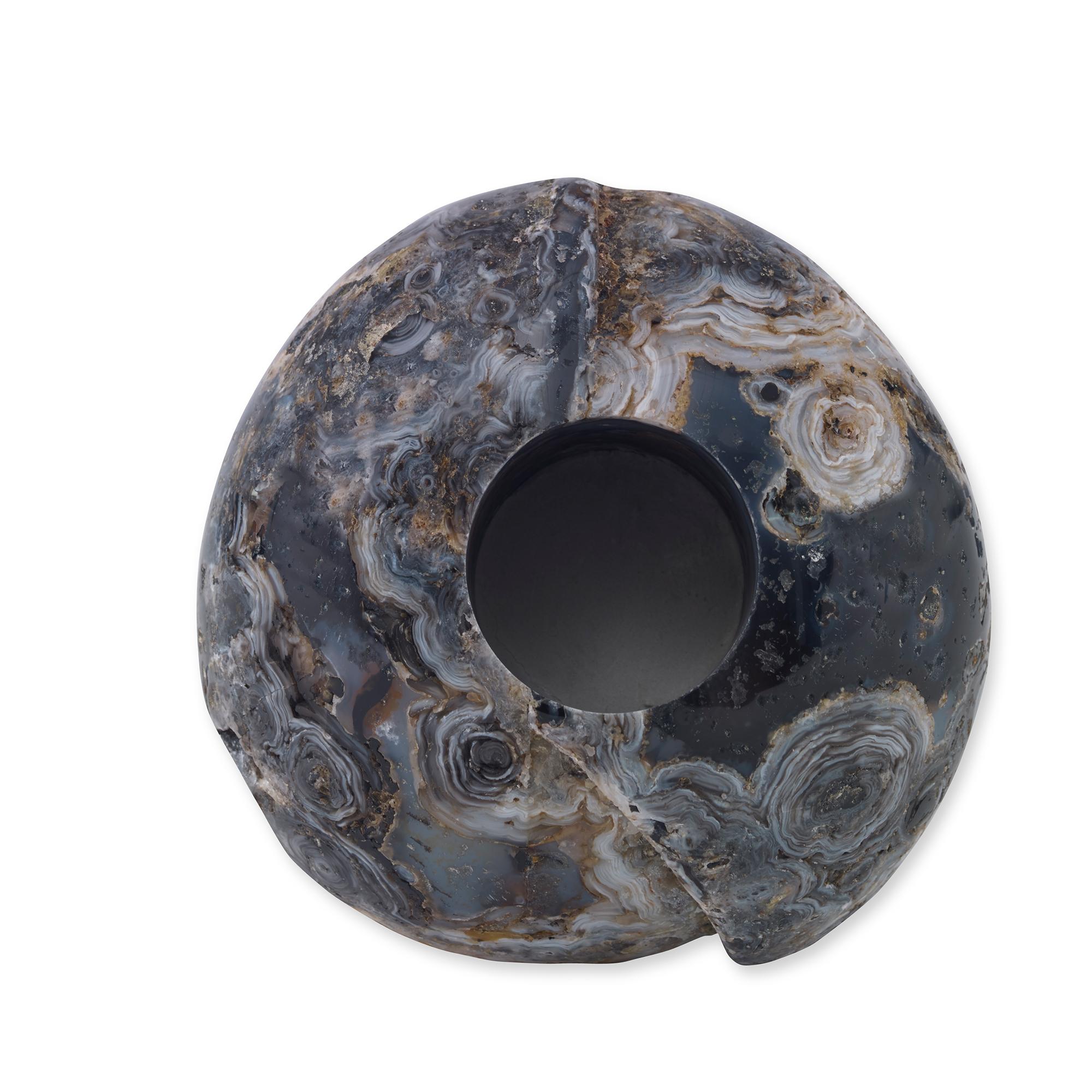 A polished, free form natural agate vase. Due to the natural material, variation in size, shape, and color is to be expected.
      