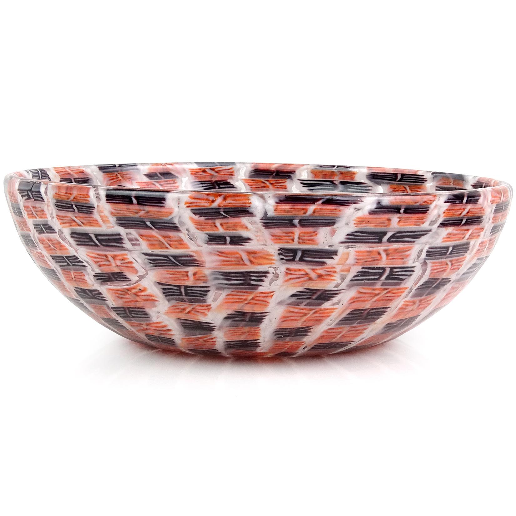 Beautiful, large and rare, vintage Murano hand blown mosaic white, black and orange murrines Italian art glass bowl. Documented to designer and painter Riccardo Licata for Venini, circa 1950s. It has an intricate murine design, stacked and