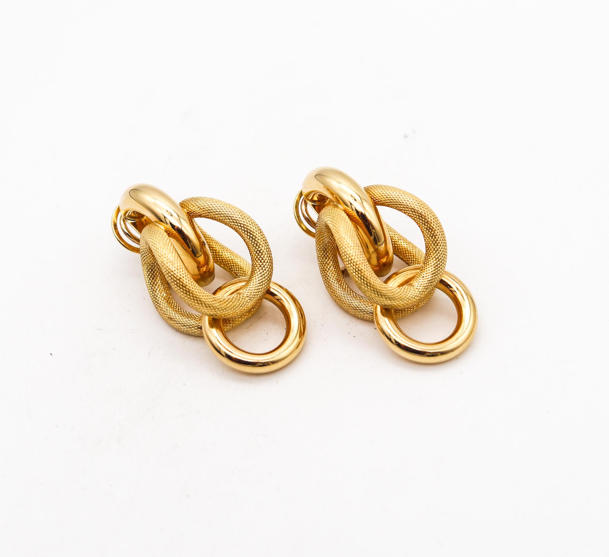 Sculptural earrings designed by Riccardo Marotto.

A statement pair of sculptural earrings, created in Vicenza Italy at the jewelry atelier of Riccardo Marotto, back in the late 20th century. These pair were made up with multiples curved tubular