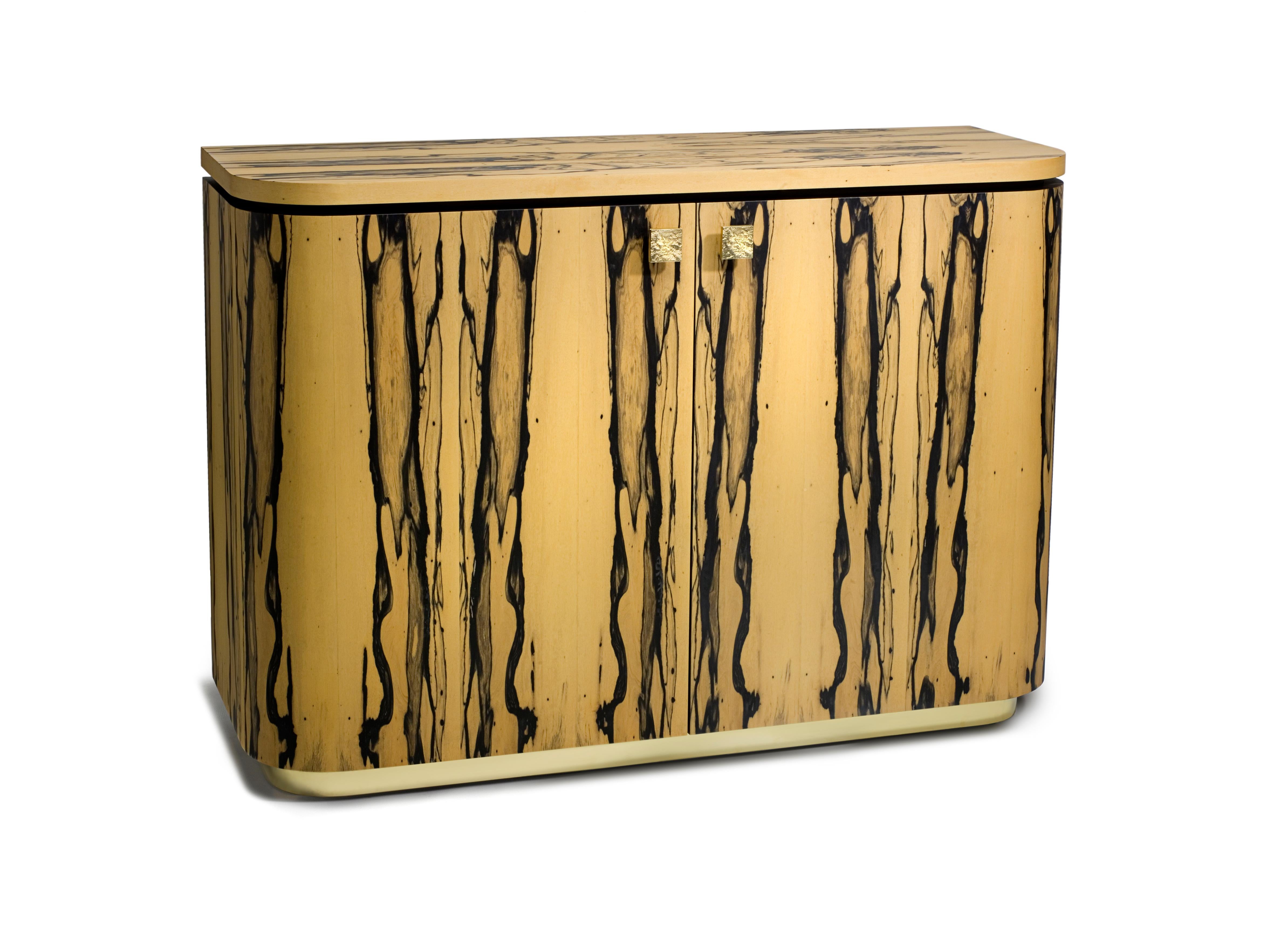 Inspired by the sweeping lines of Art Deco pieces the Riccardo sideboard was designed by Simon Stewart for Charles Burnand.

The curved front, sides and back in striking white ebony veneer contrasts with the Macassar ebony interior and glass
