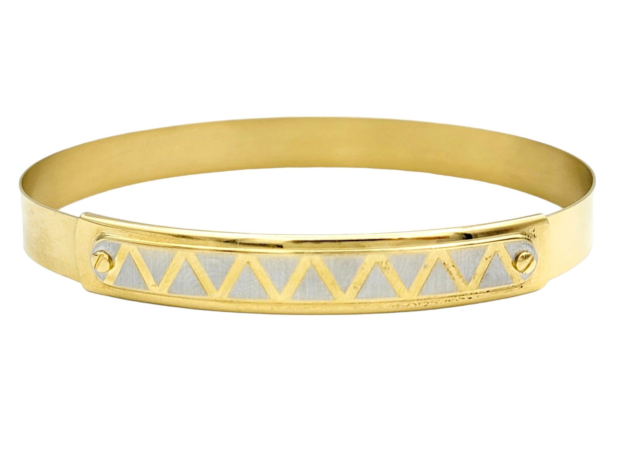 This enchanting bangle bracelet, a creation by Ricciolo d'Oro, epitomizes elegance and versatility in fine jewelry. Meticulously crafted from opulent 18 karat gold, the bracelet boasts a slender and adjustable design, ensuring a perfect fit through