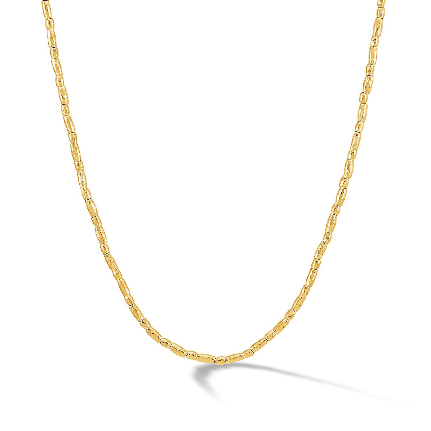 18ct yellow gold vermeil on a sterling silver necklace made of caraway 'rice' cylinder beads threaded onto chain. The necklace is finished with our signature hammered loop and t-bar clasp.

We have been creating a wonderful world of everyday and