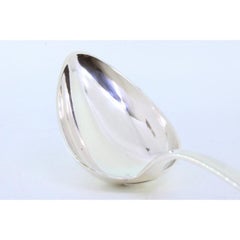 Rice spoon and serving dish in silver with grooves along the handle