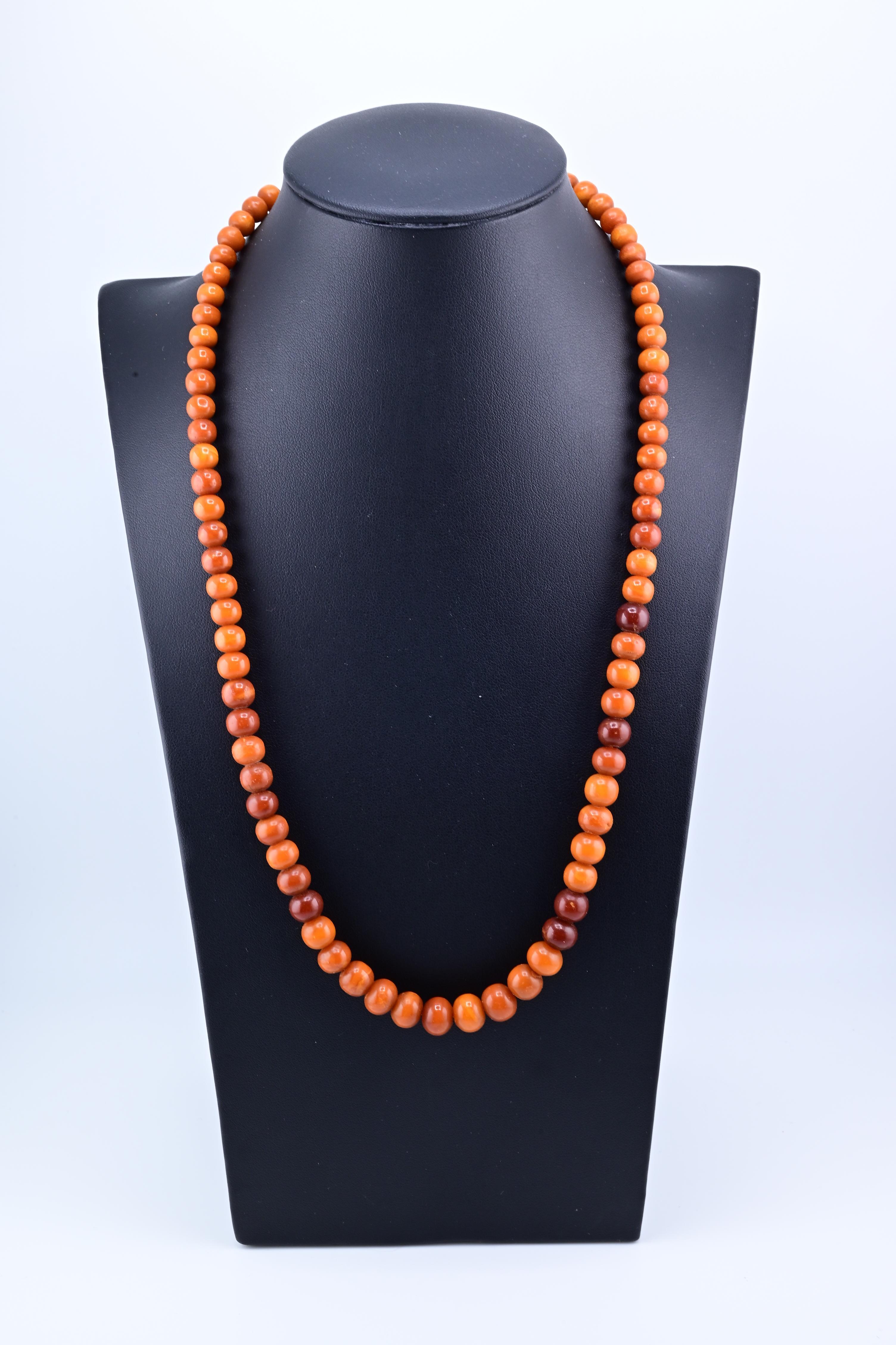 This is a amber beaded necklace made of round, polished beads in varying shades of warm orange and brown. The beads are made from natural amber.
Amber necklaces, particularly those made from Baltic amber, are valued for their organic origin and