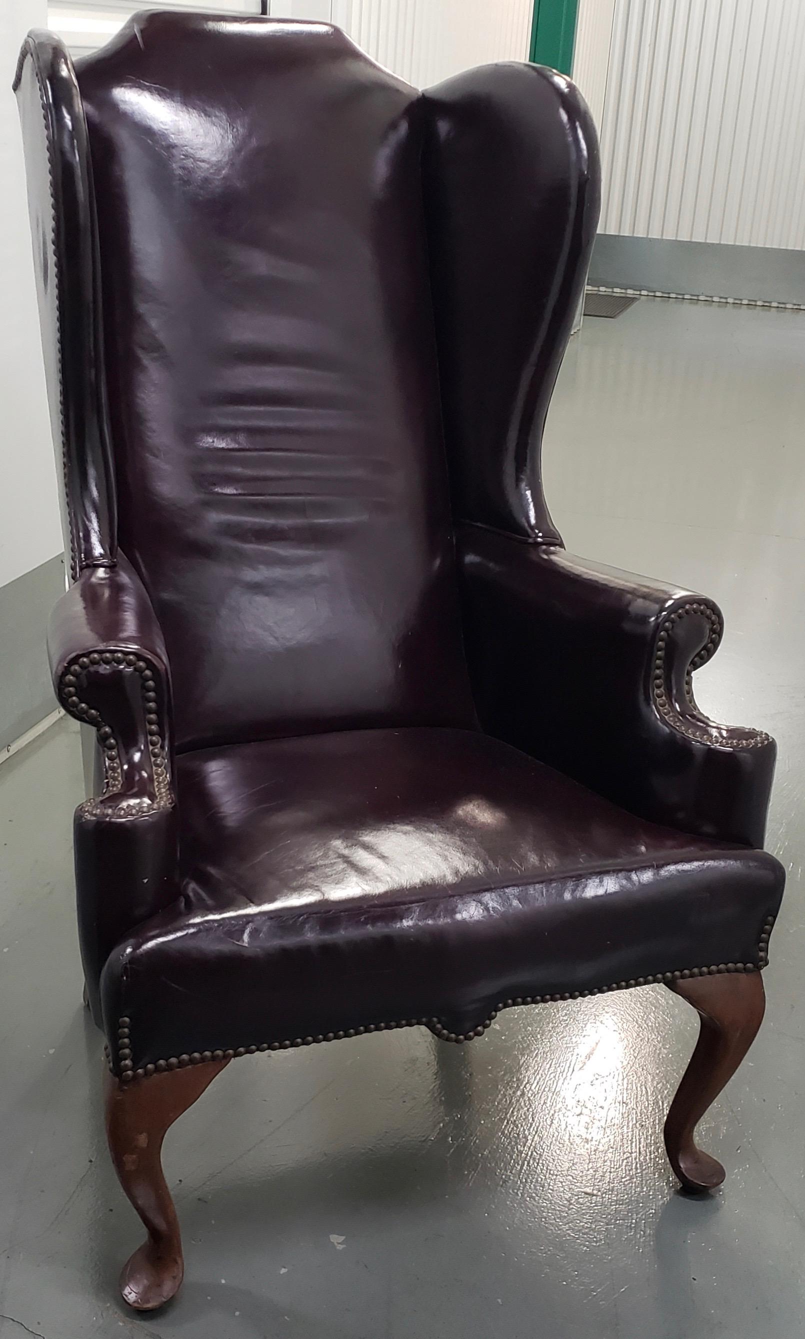 Rich burgundy patent leather wing back chair, circa 1920

Absolutely beautiful 1920s wingback chair made with rich burgundy patent leather over a solid mahogany frame. The leather is supported by brass tacks that have a rich patina that can only