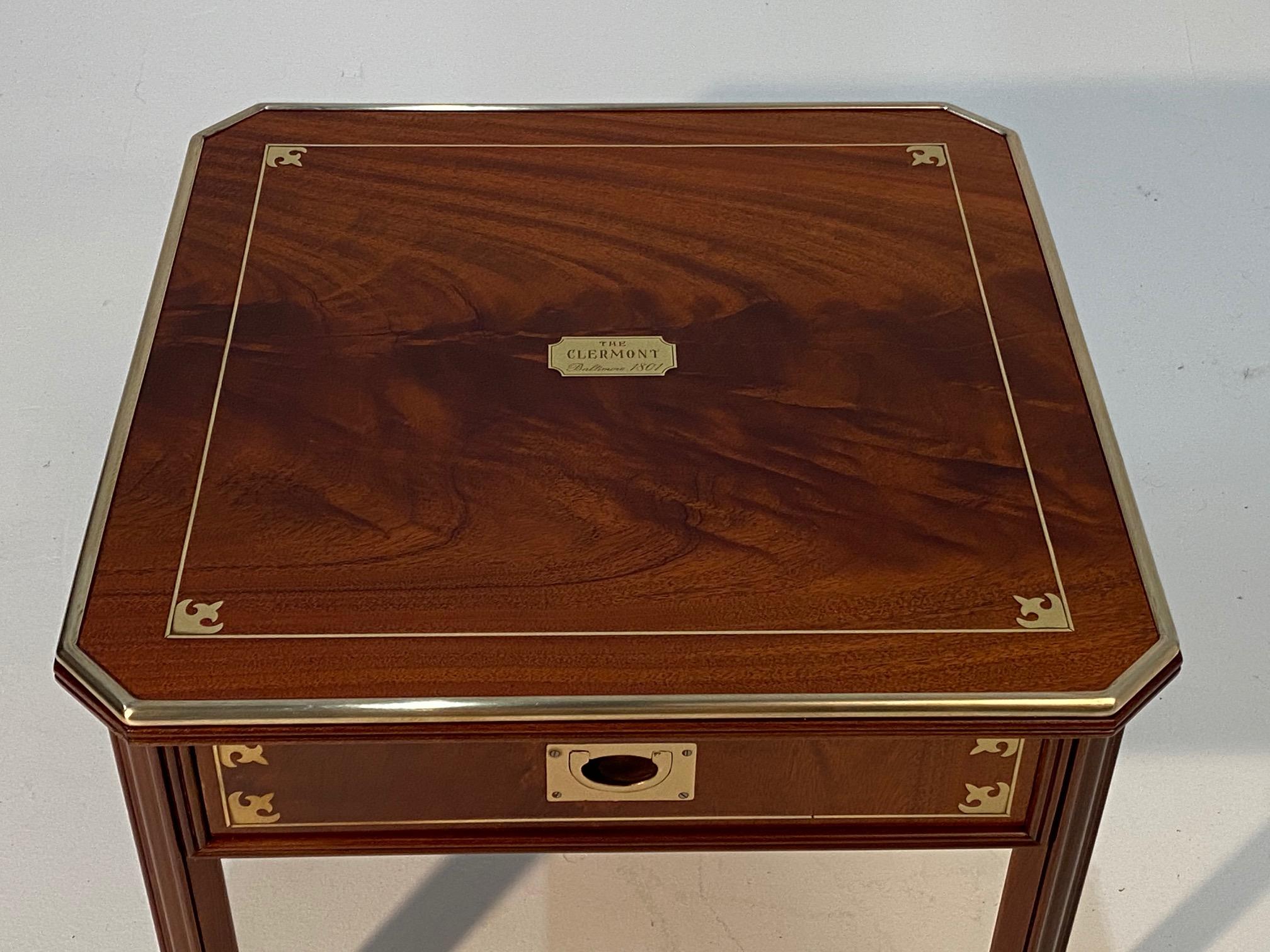 Handsome square mahogany Campaign style end or side table having brass inlay, molding as well as dovetailing. Beautiful craftsmanship and interesting provenance. Made for the Clermont Hotel in Baltimore est. 1801.