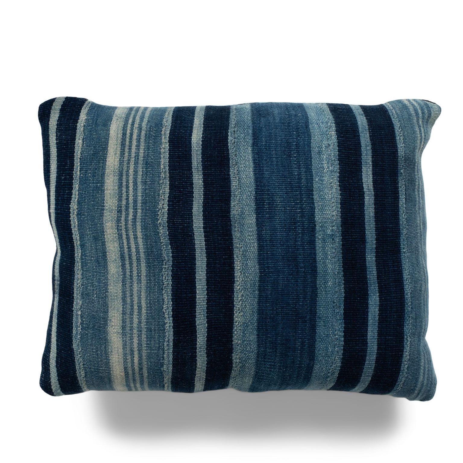 Rich faded indigo stripe cushion made from vintage handwoven and hand-dyed slubby cotton fabric. This decorative pillow includes a zip fastener and feather insert. Two available. Sold separately and priced $480 each.