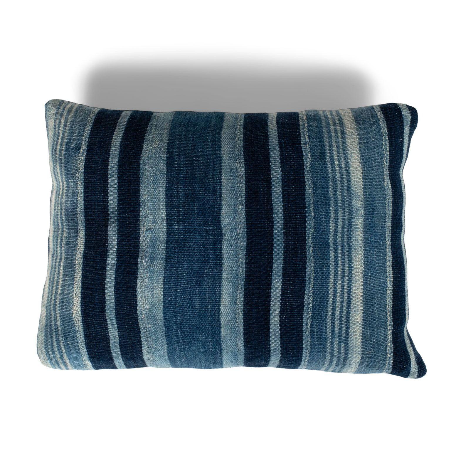 Rich faded indigo stripe cushion made from vintage handwoven and hand-dyed slubby cotton fabric. This decorative pillow includes a zip fastener and feather insert. Two available. Sold separately and priced $480 each.
