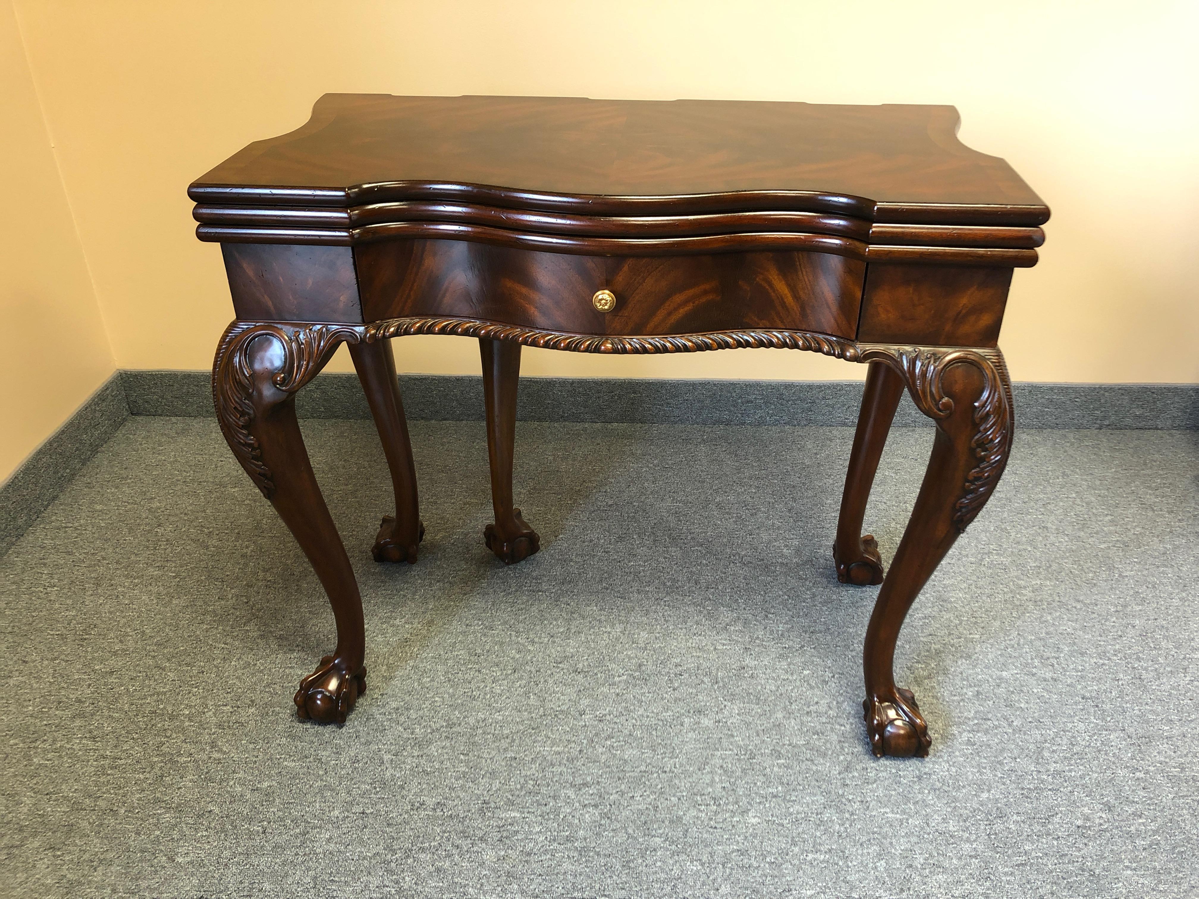 A beautifully made game table by Maitland-Smith with a variety of looks and uses. One surface is a rich flame mahogany inlaid game table for checkers, backgammon or checkers. A second top folds over to replace the game table with a sumptuous tooled