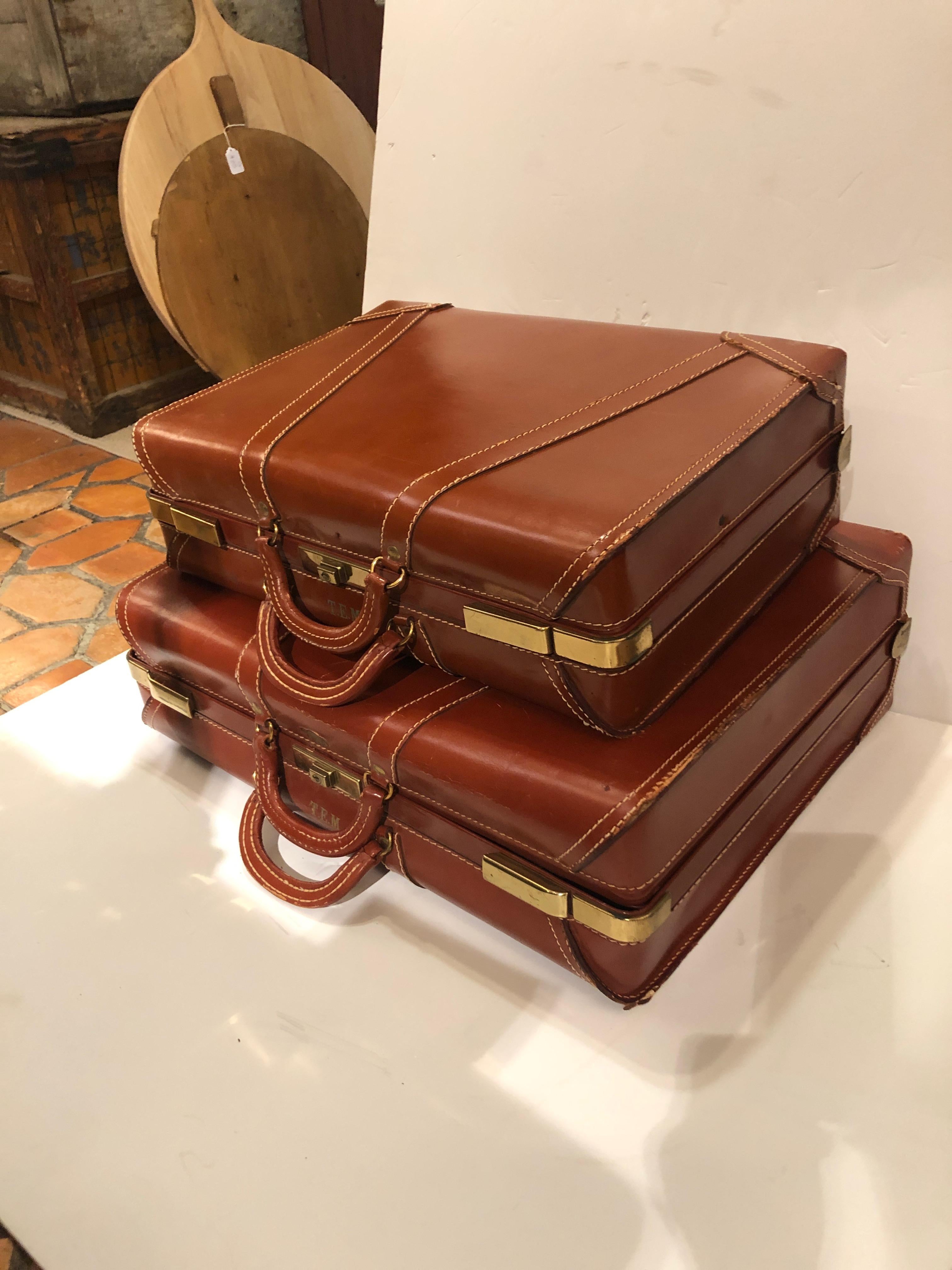 A handsome pair of authentic leather and brass vintage suitcases that add a touch of nostalgic accessorizing. Stacked they look great and function as a coffee table or end table.
Smaller suitcase is 21 W, 14.5 H, 6 D.