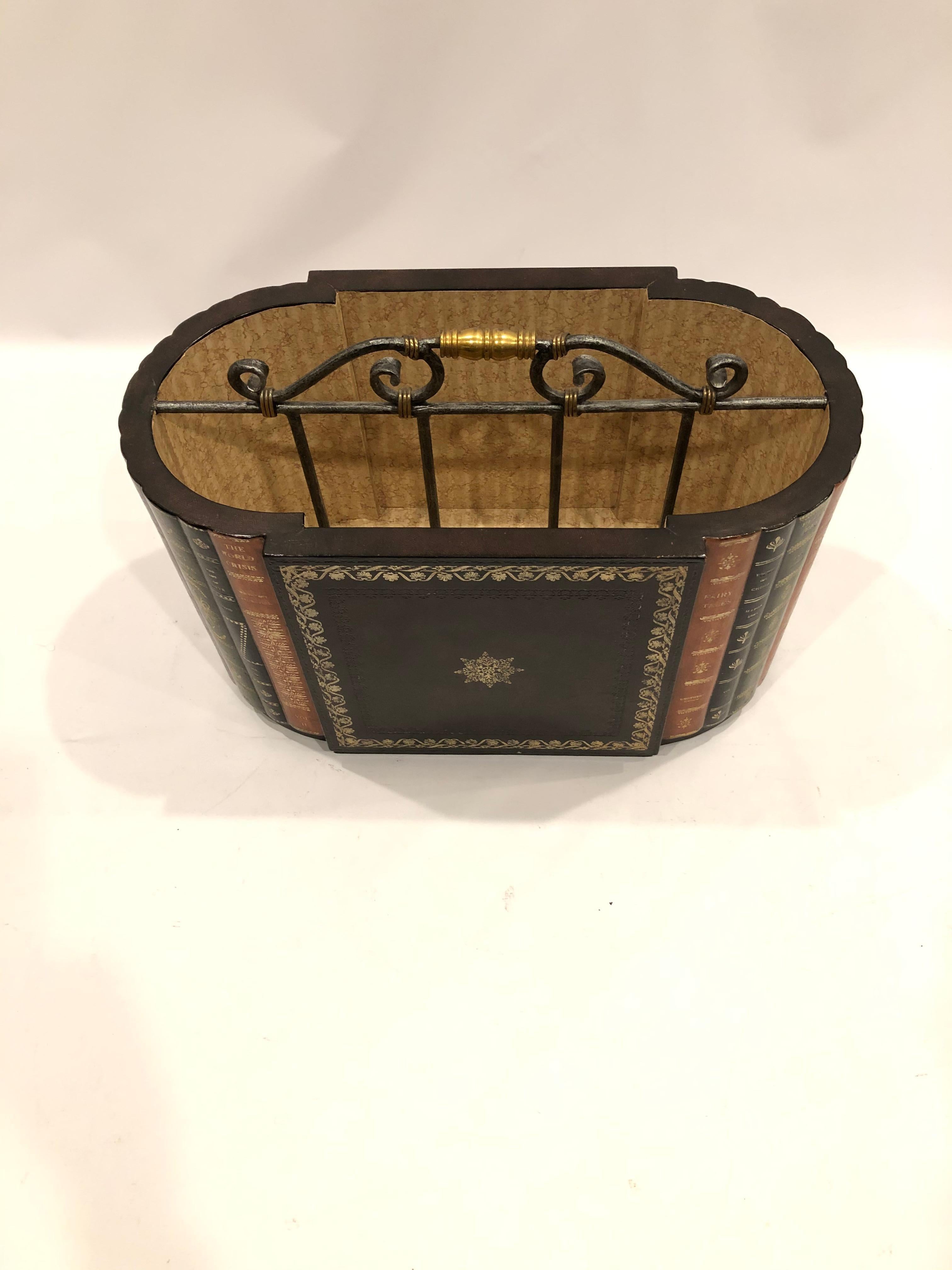 Beautifully made magazine rack canterbury combining faux leather book bindings, tooled leather panels, hammered iron and brass handle and paper lining.
