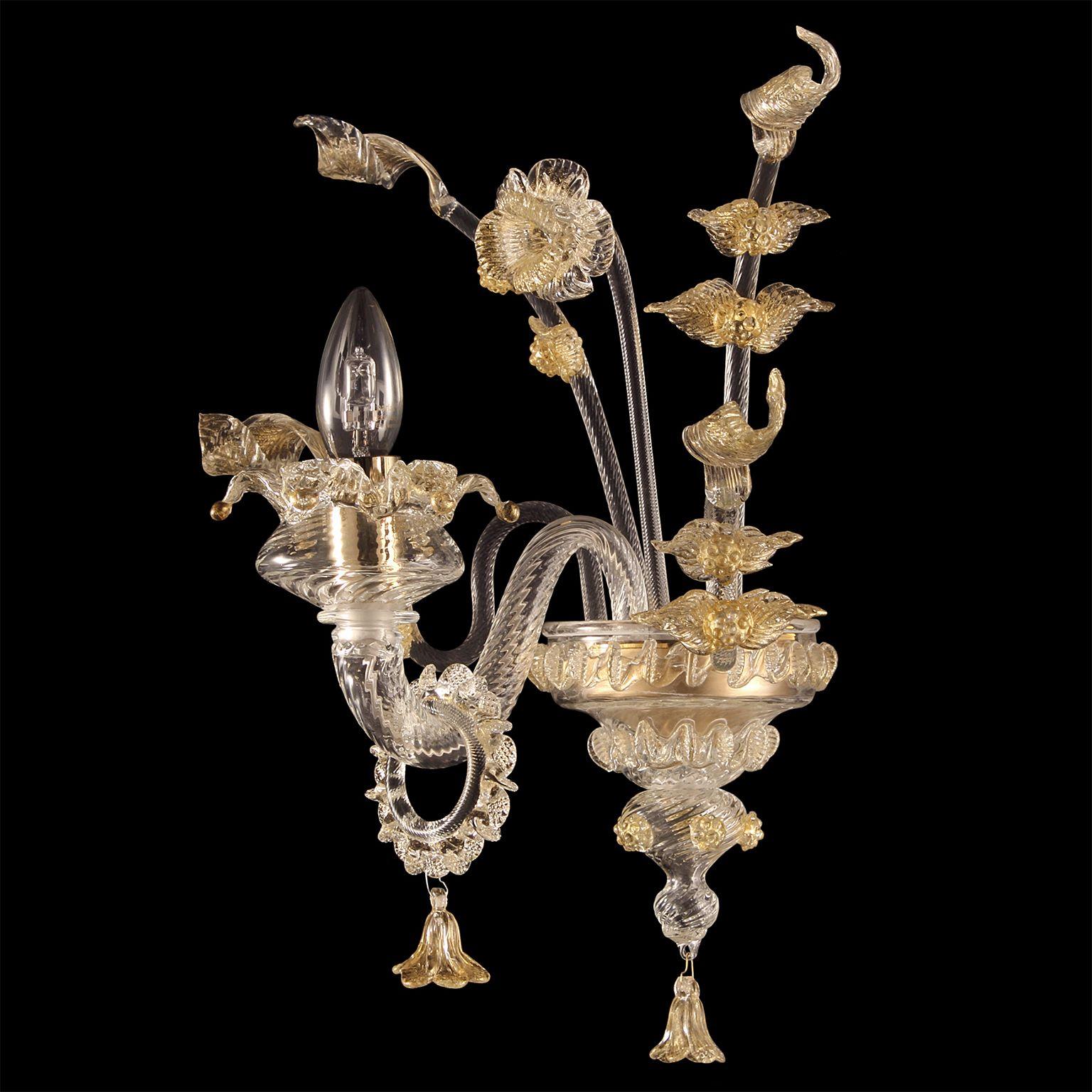 Rich Murano sconce 1 Arm crystal and gold murano glass Fenix by Multiforme.
The blown glass chandelier Fenix, with its floral style, harks back to the venetian classic tradition. The decorative elements are characterized by flowers modelled petal