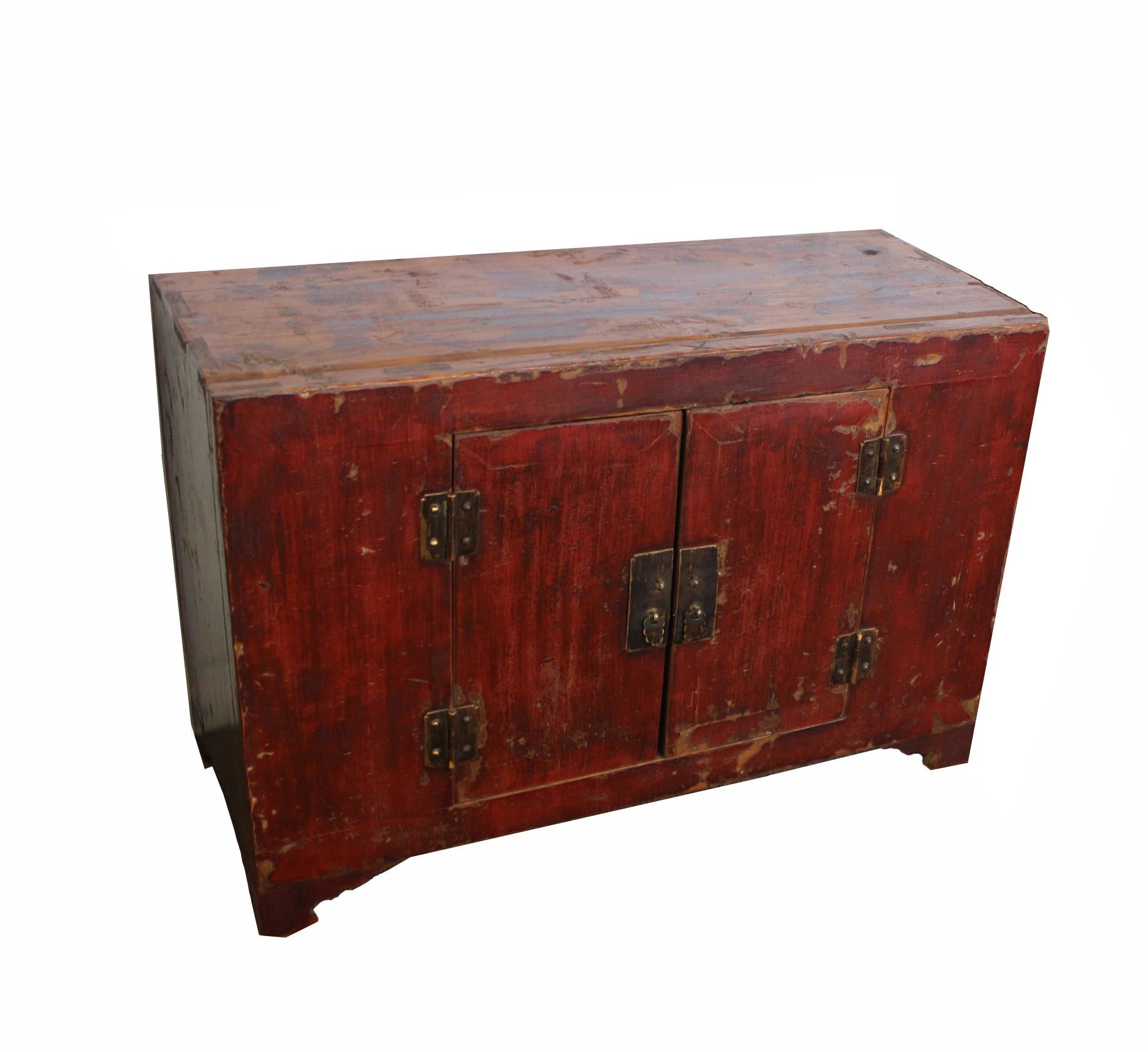 The paint on this antique Chinese cabinet is still original. The rich patina and crackling developed over a century add special characters and beauty to this cabinet. Double doors open to reveal a main compartment. Unique hand forged brass drop