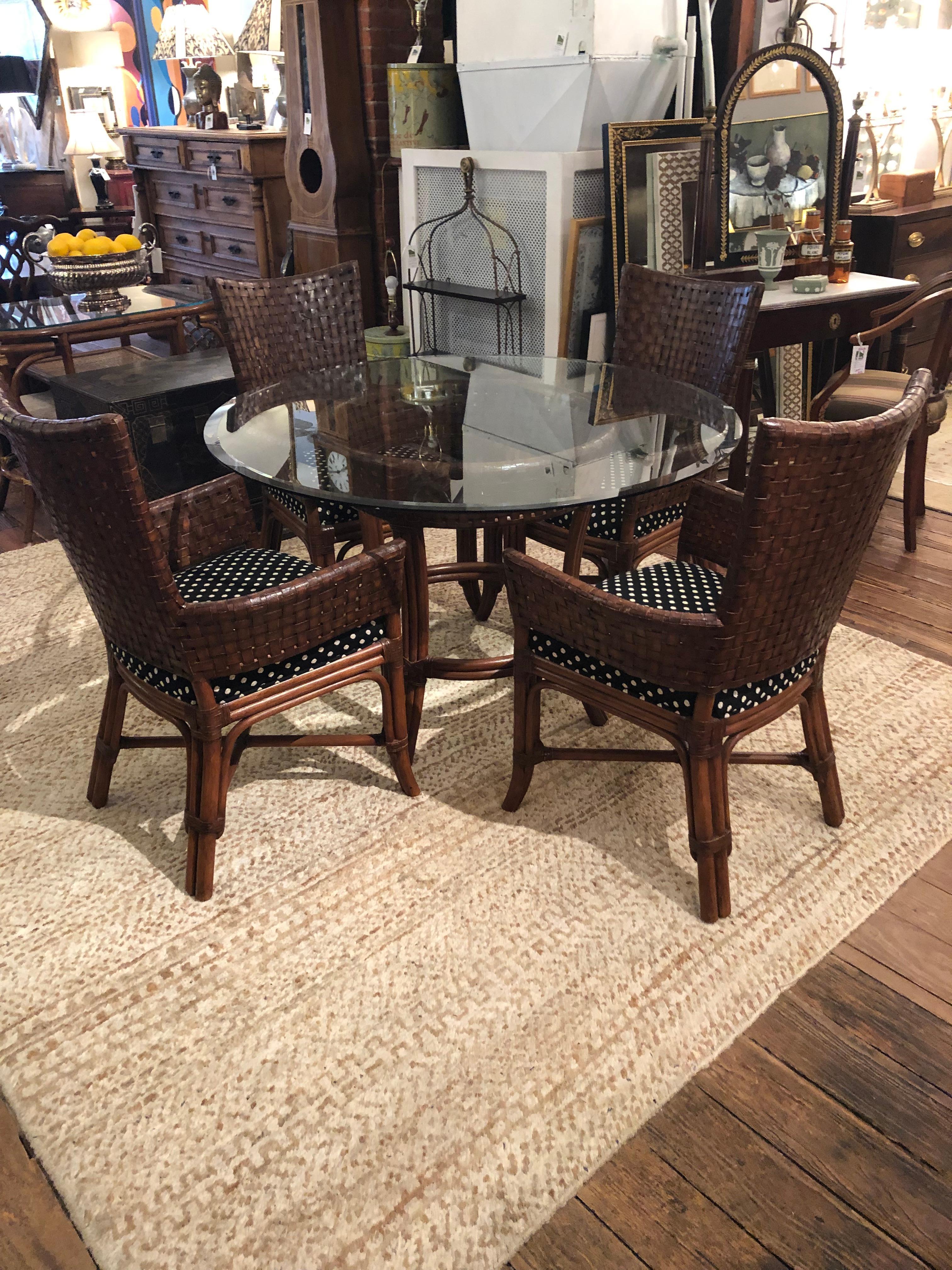 A great looking round glass table having stained bamboo base and 4 matching handsome woven leather & bamboo armchairs with updated polka dot upholstered seats.
Chairs 24 W 19 D 38 H.
seat height 18.
