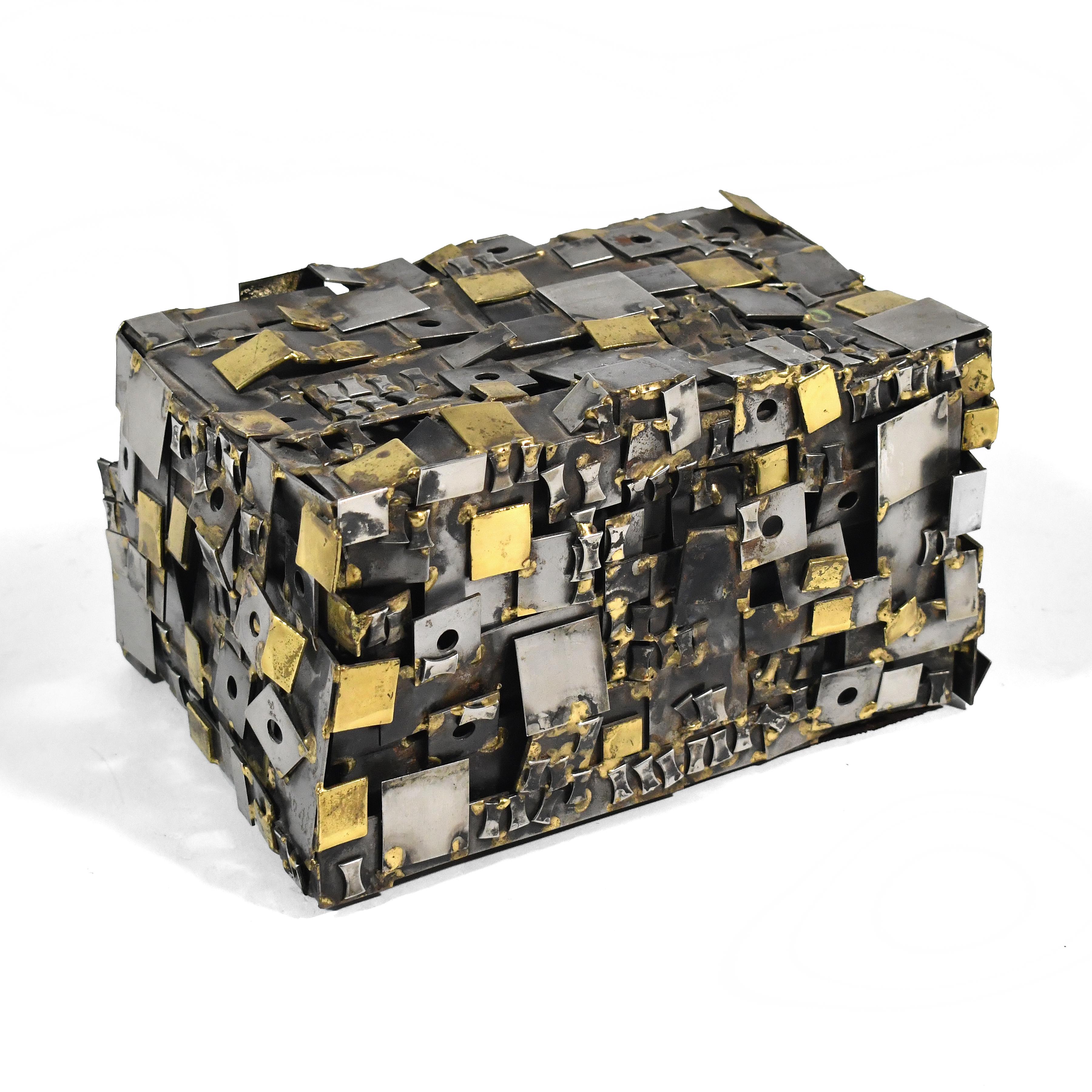 This striking brutalist piece by Chicago artist Richard Bitterman is as much a sculpture as a functional jewelry box. The highly active and textural surface is created of a patchwork of shapes in brass and chromed steel. It has a cleverly hidden