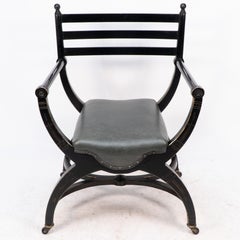 Richard Charles Aesthetic Movement Silla de codo ebonizada con bastidor en X