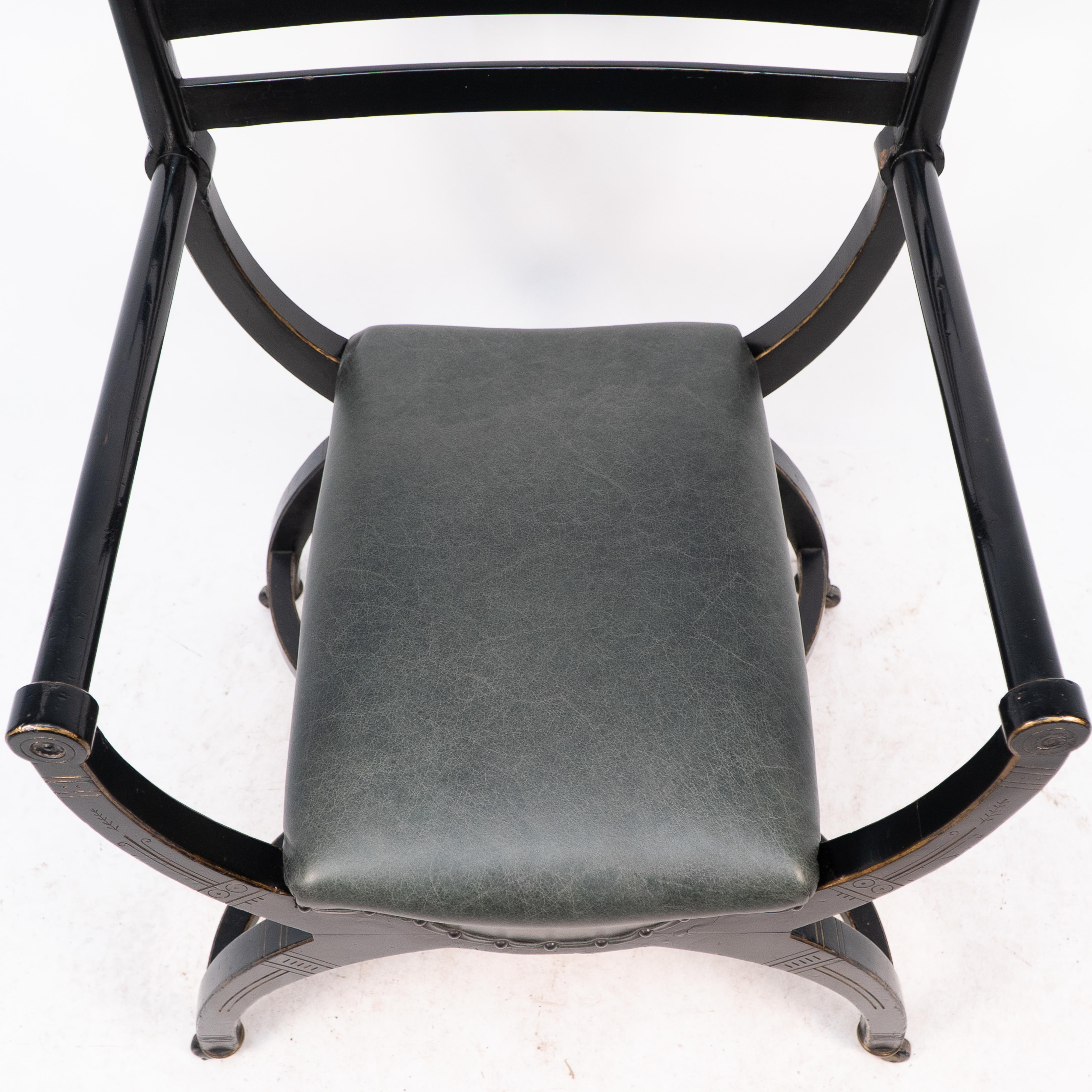Ebonized Richard Charles Aesthetic Movement Ebonised Elbow Chair with X Frame stretcher For Sale