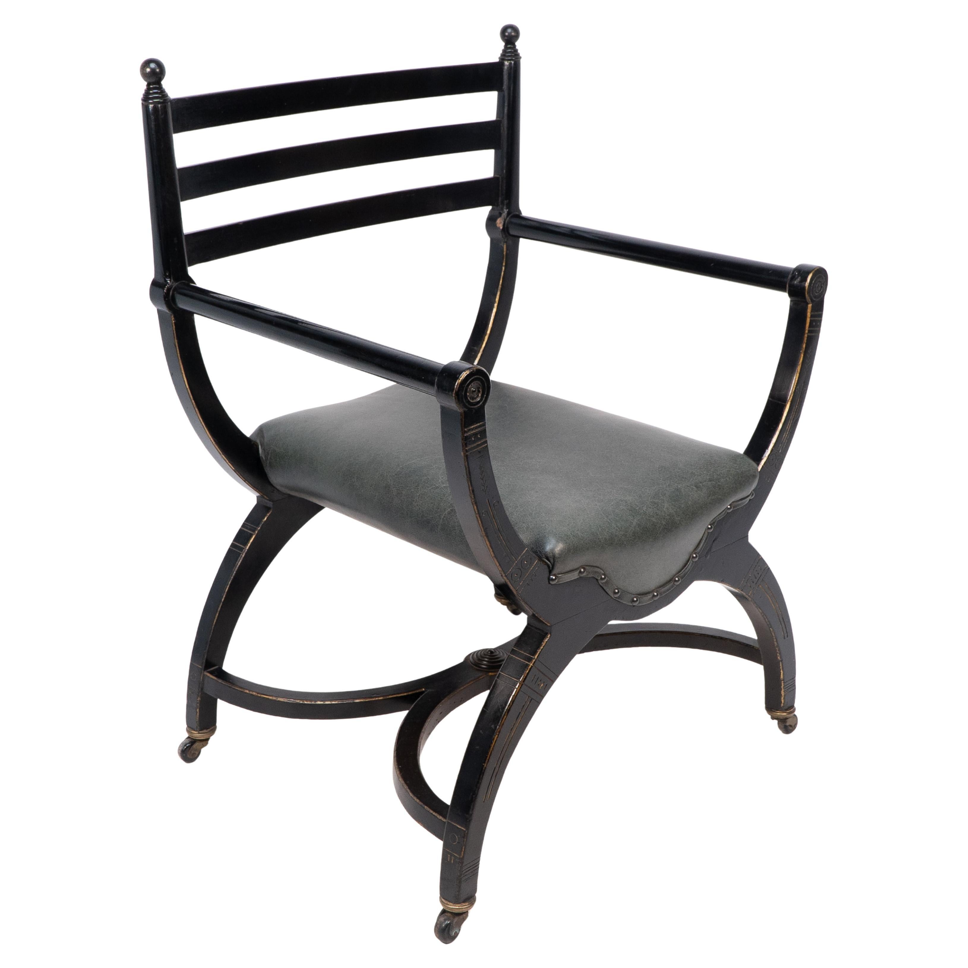 Richard Charles Aesthetic Movement Ebonised Elbow Chair with X Frame stretcher