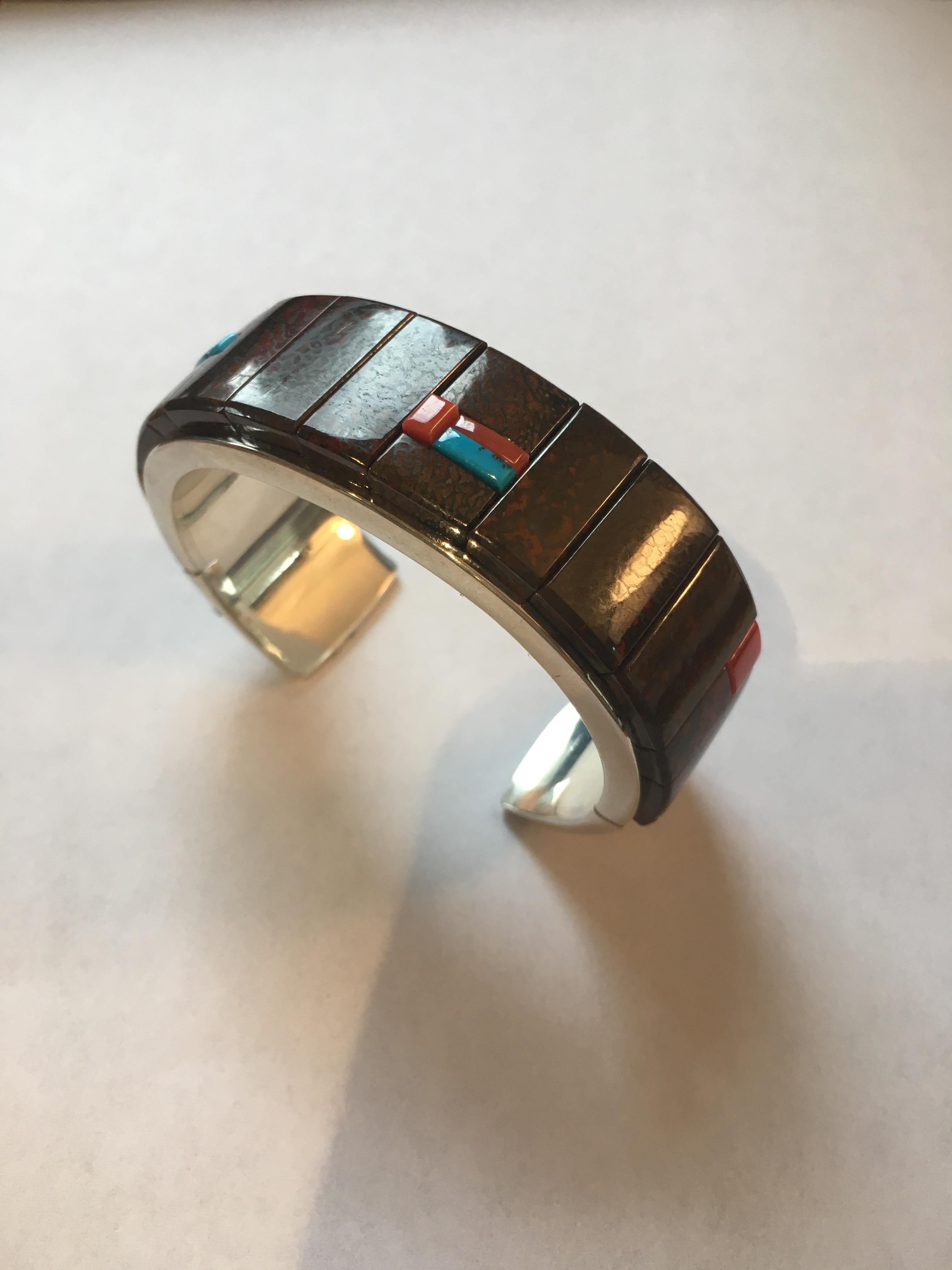 A fossilized dinosaur bone, coral, turquoise and sterling silver cuff, by Richard Chavez (San Felipe Pueblo), 2016. Stamped with maker's mark, 925. 
This cuff is 0.80
