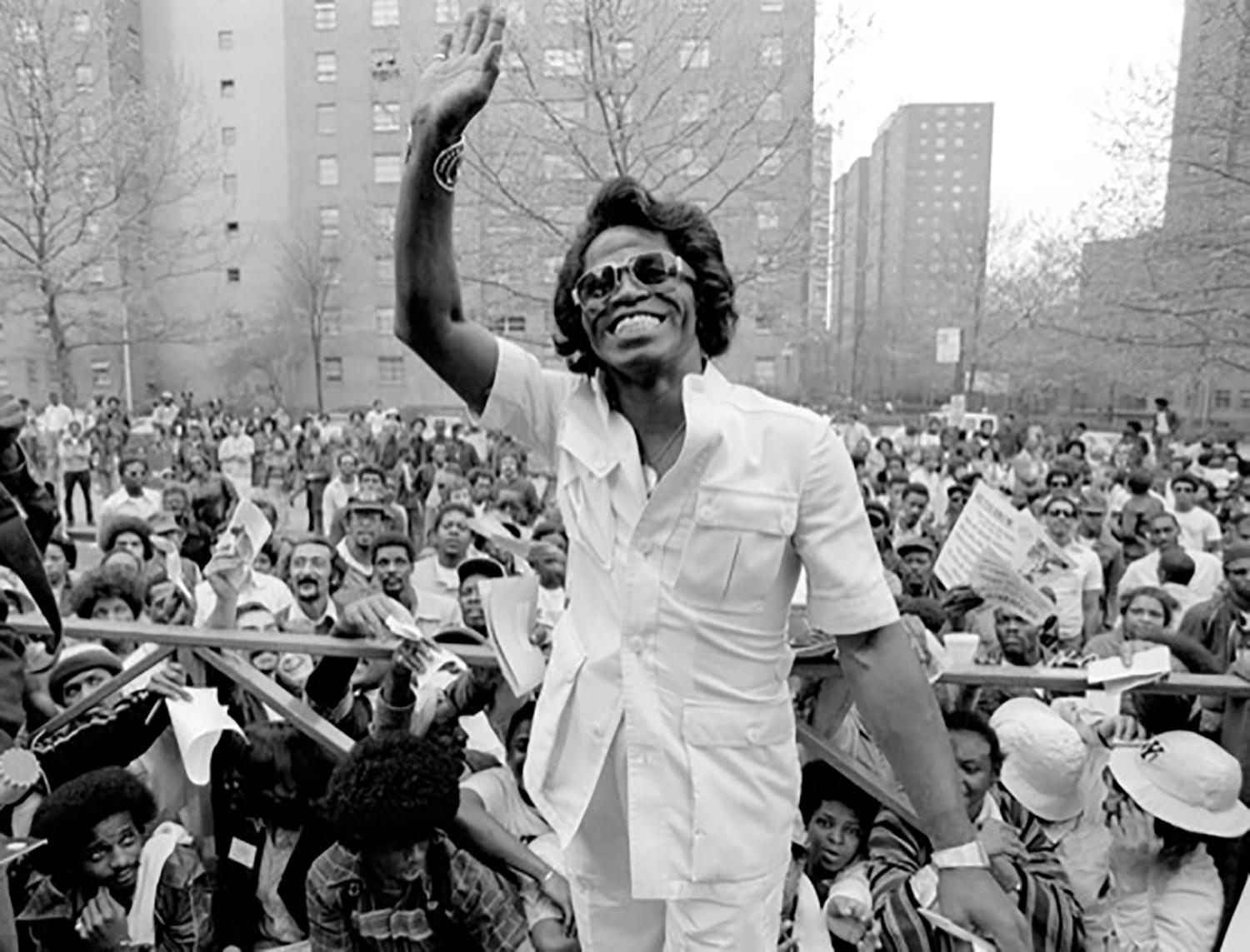 Richard E. Aaron Black and White Photograph - James Brown 1979 in Harlem Waiving