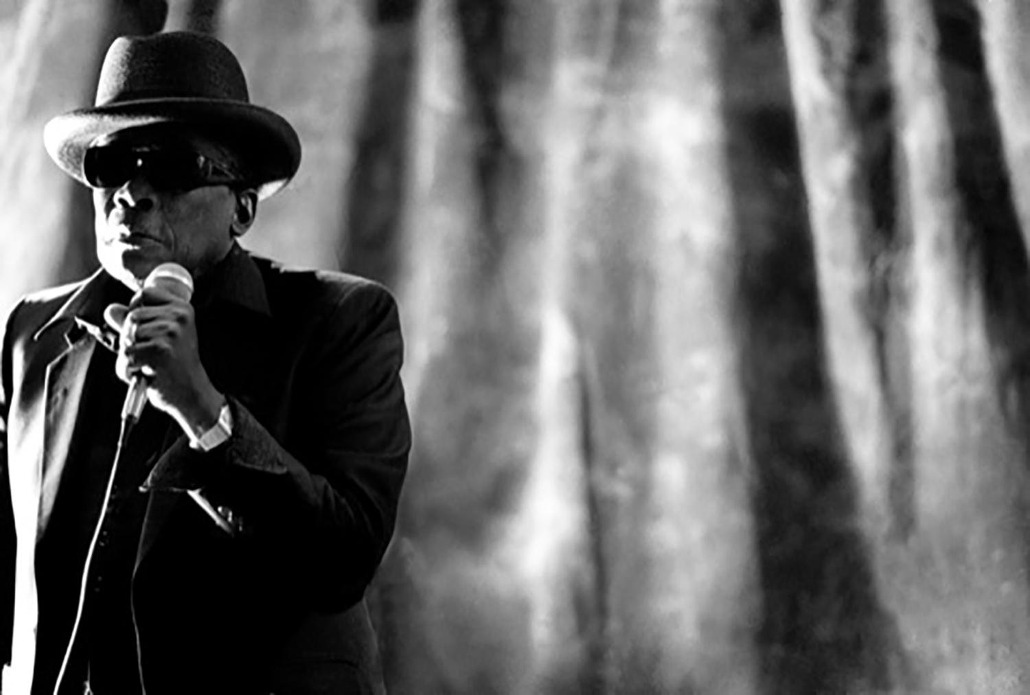 Richard E. Aaron Black and White Photograph - Johnnie Lee Hooker with a Microphone