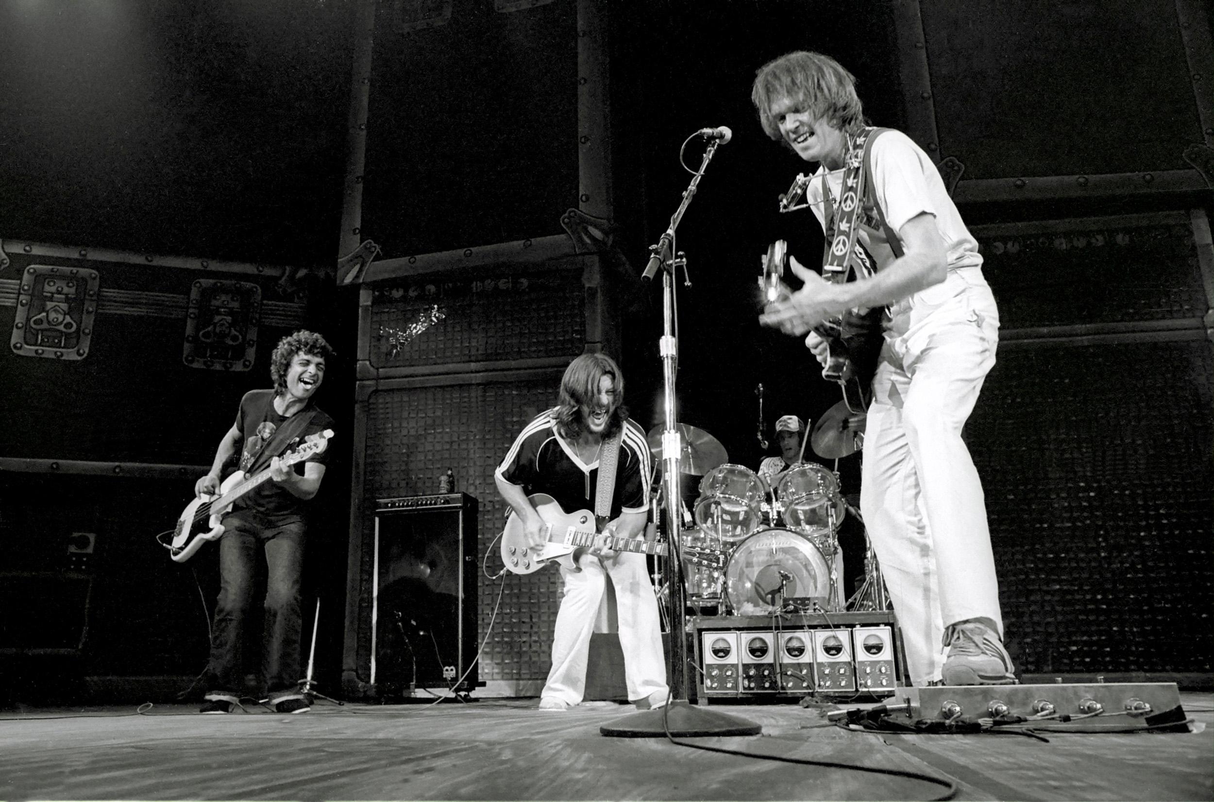 Richard E. Aaron Black and White Photograph - Neil Young Performing with Band