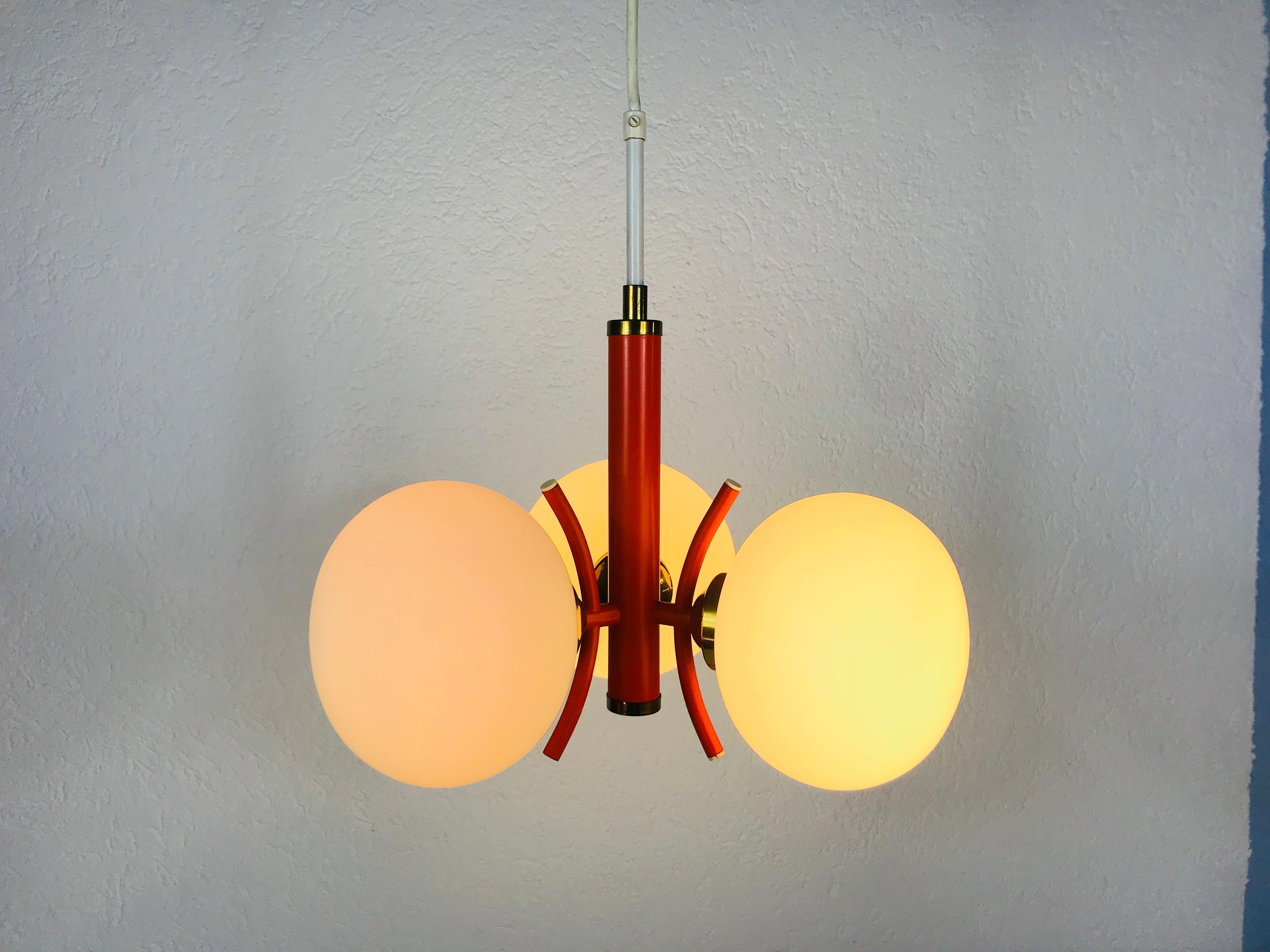 A Richard Essig chandelier made in Germany in the 1960s. It is fascinating with its space age design and three opaque balls. The body of the light is made of full metal, including the arms.


The light requires three E14 light bulbs.